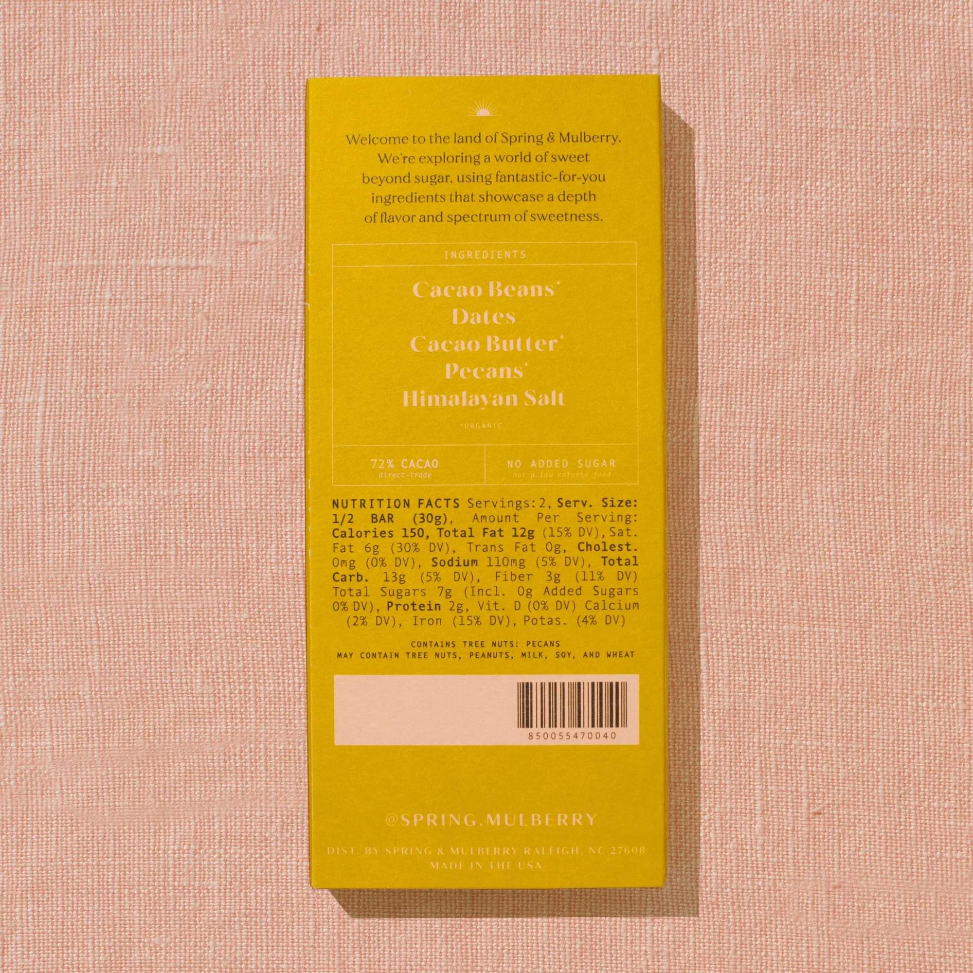 Yellow candy bar box on a pink textured surface