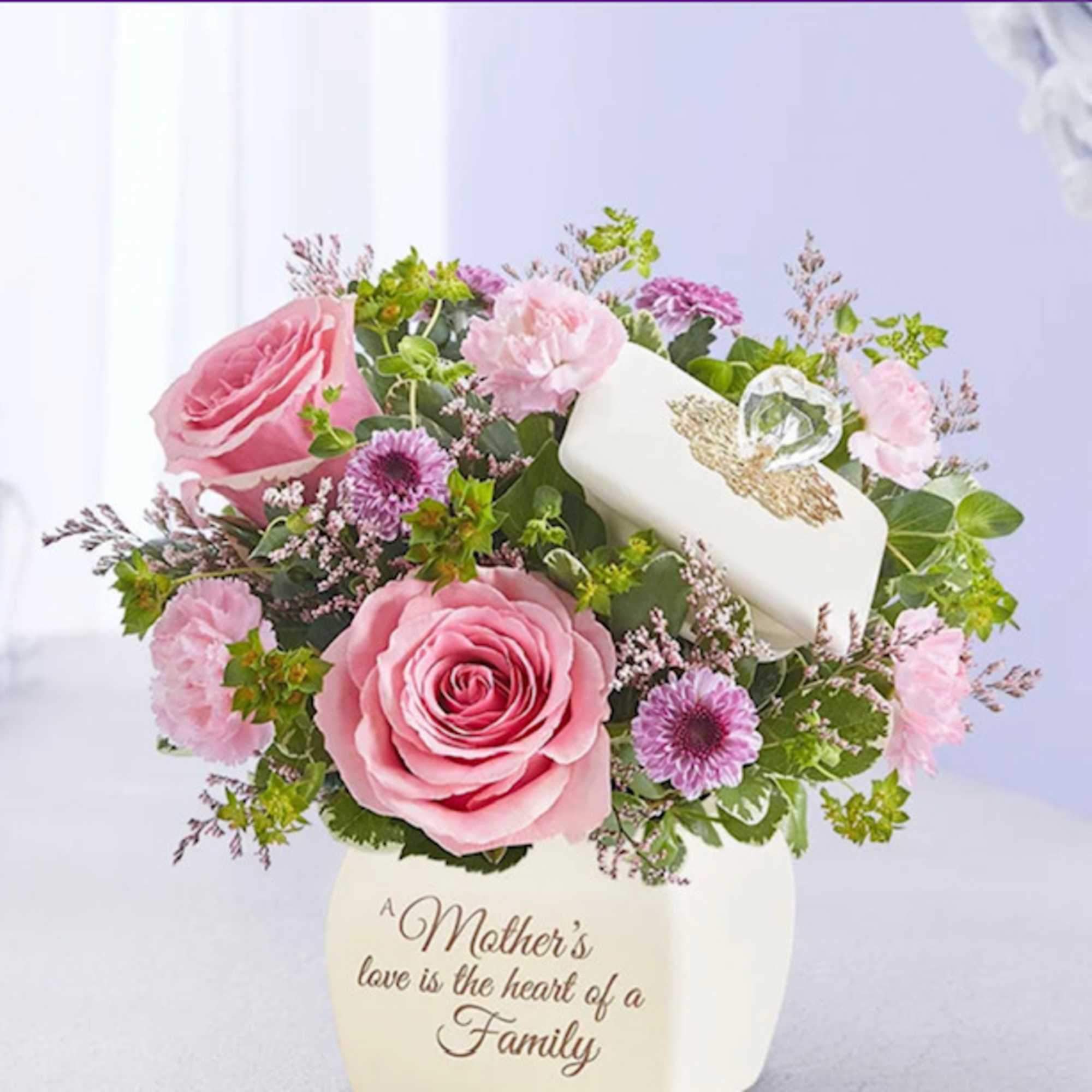 Pink roses, carnations, and purple mums in a cream vase with a keepsake box and crystal heart accent