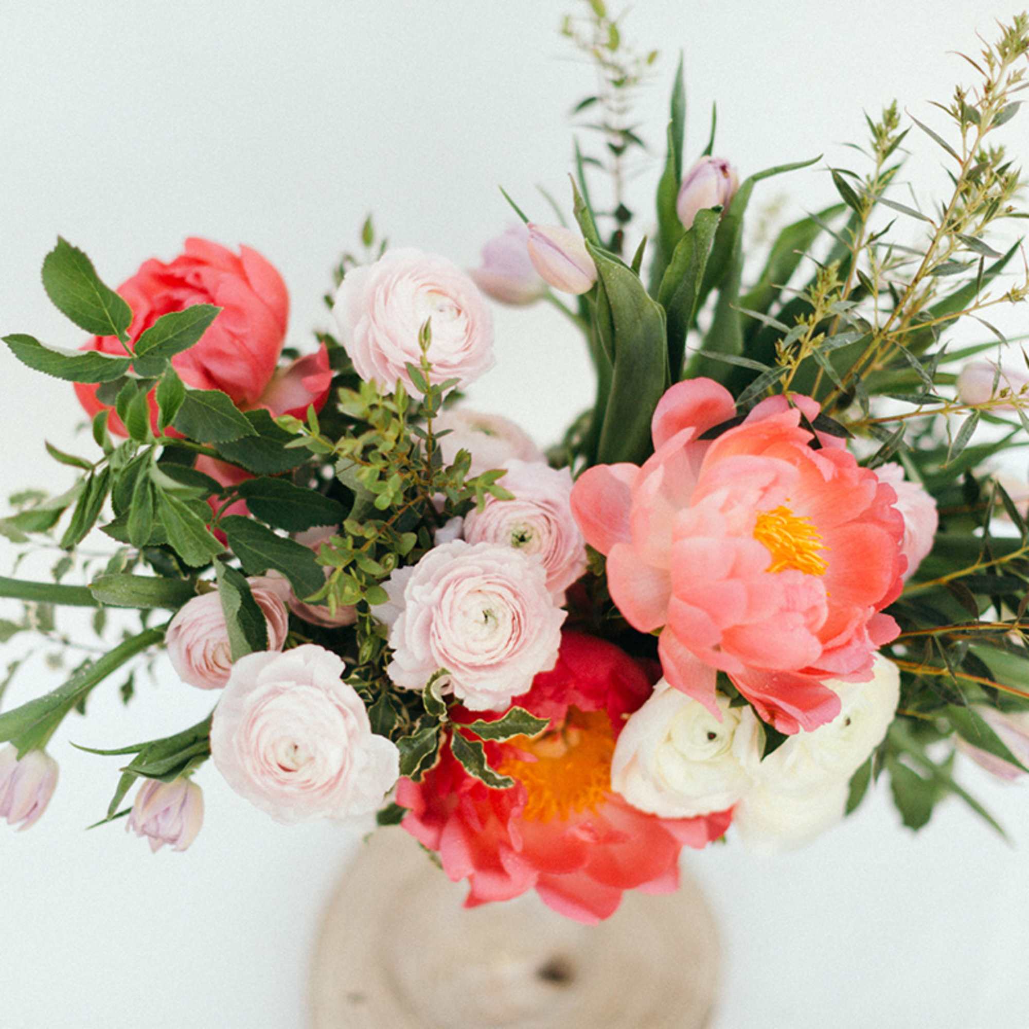 Bouquet of coral and pale pink flowers in a vase