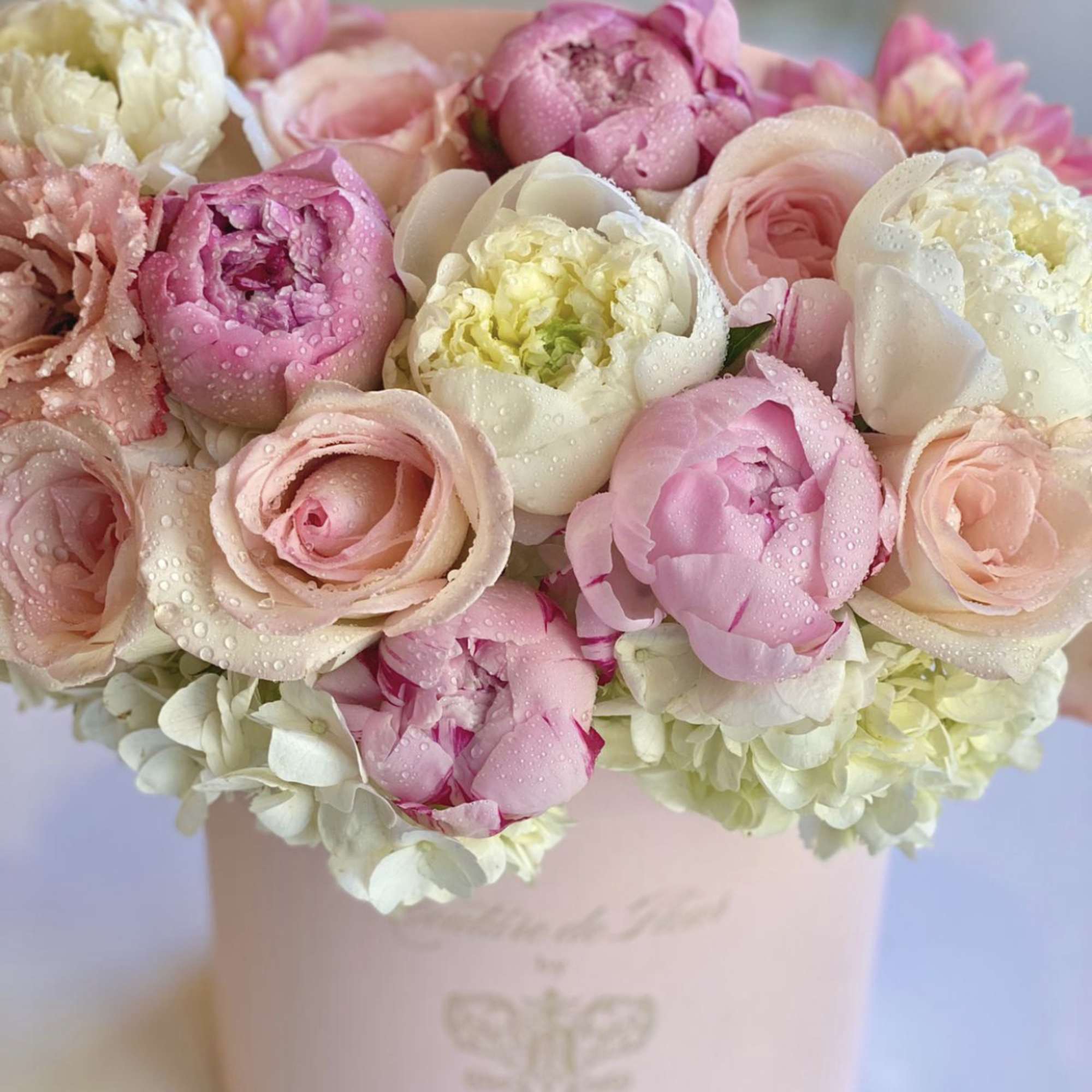Pink and white peonies and roses in a blush hat box