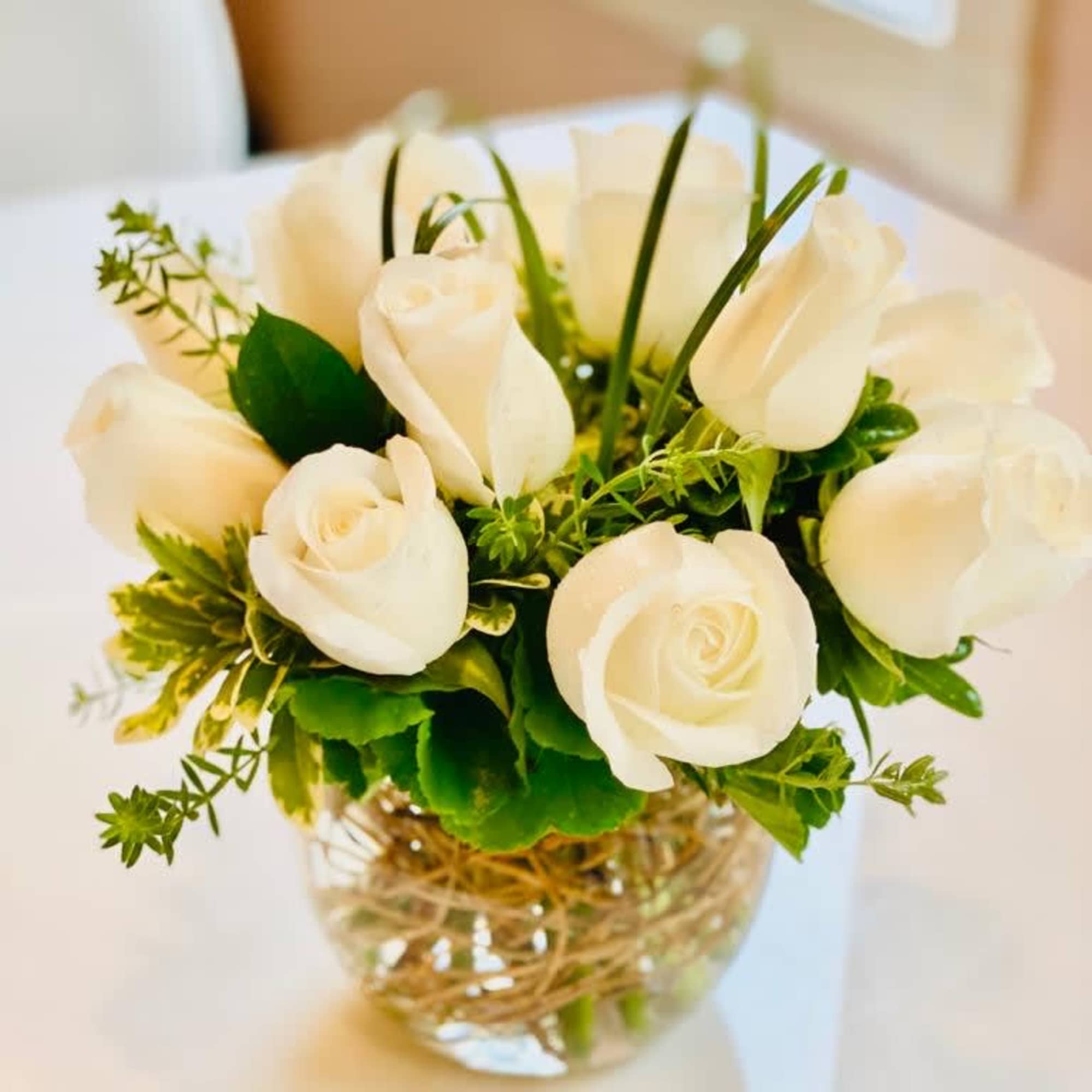 White rose bouquet in a clear glass vase