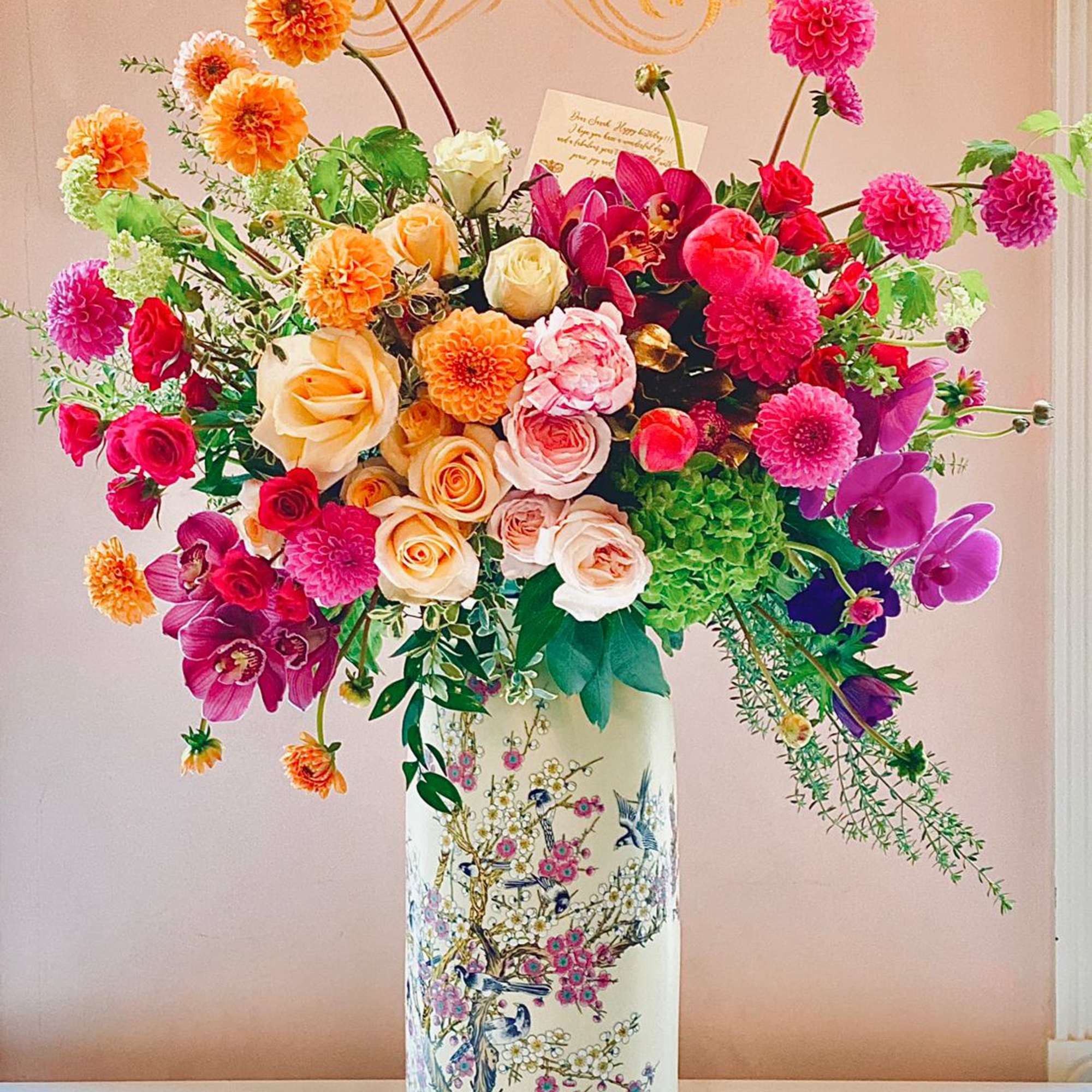 Colorful mixed flower arrangement in a tall decorative vase