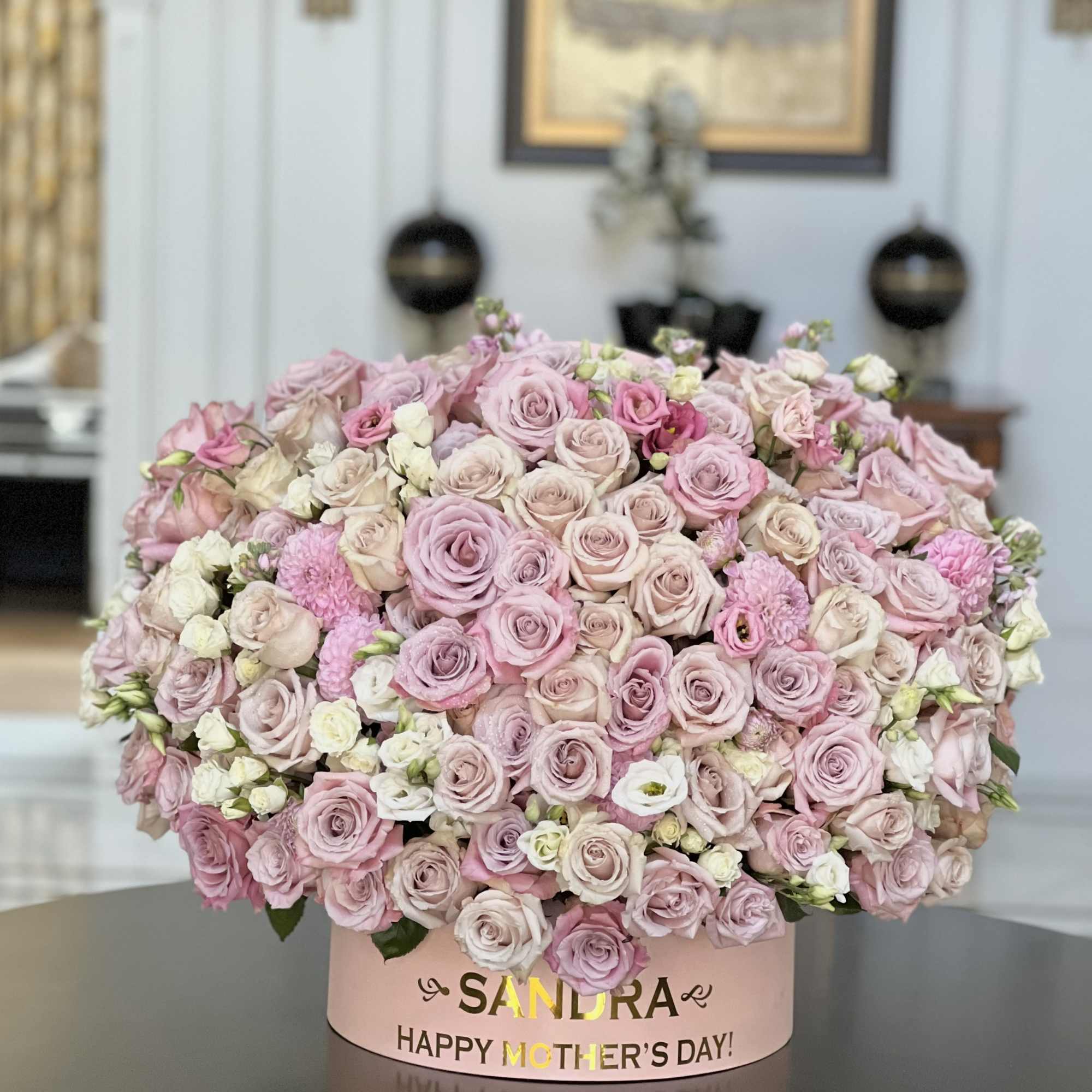 Pink rose arrangement in a round box with a Mother's Day message