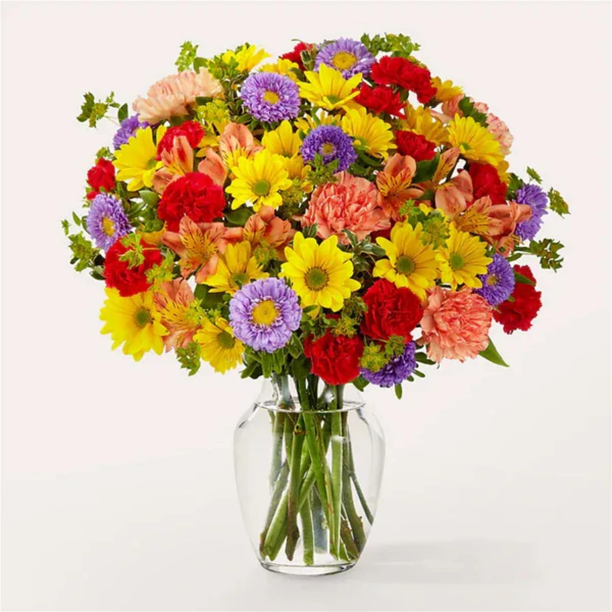 Mixed bouquet of colorful flowers in a clear glass vase