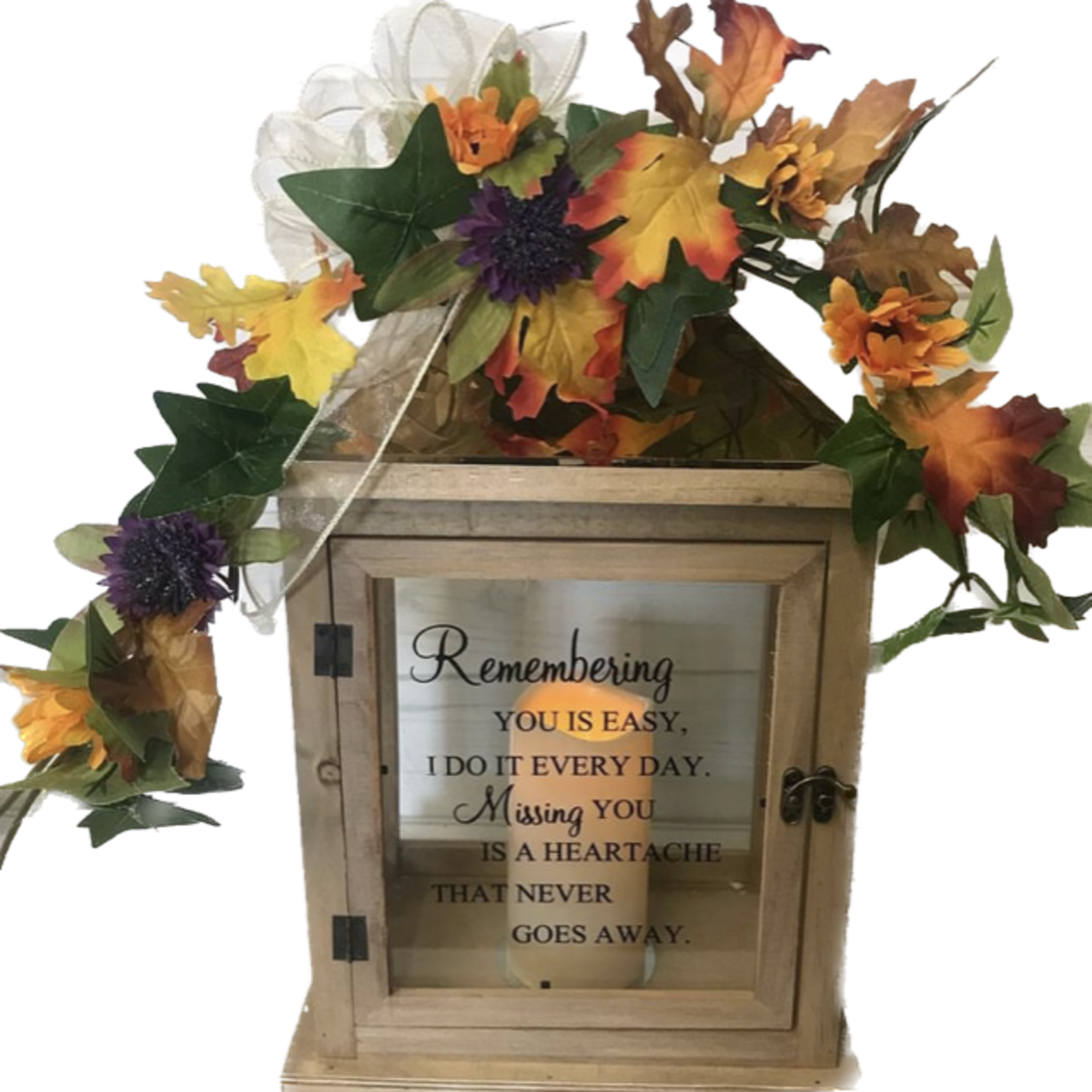 Wooden memorial lantern with autumn floral garland and a remembrance message