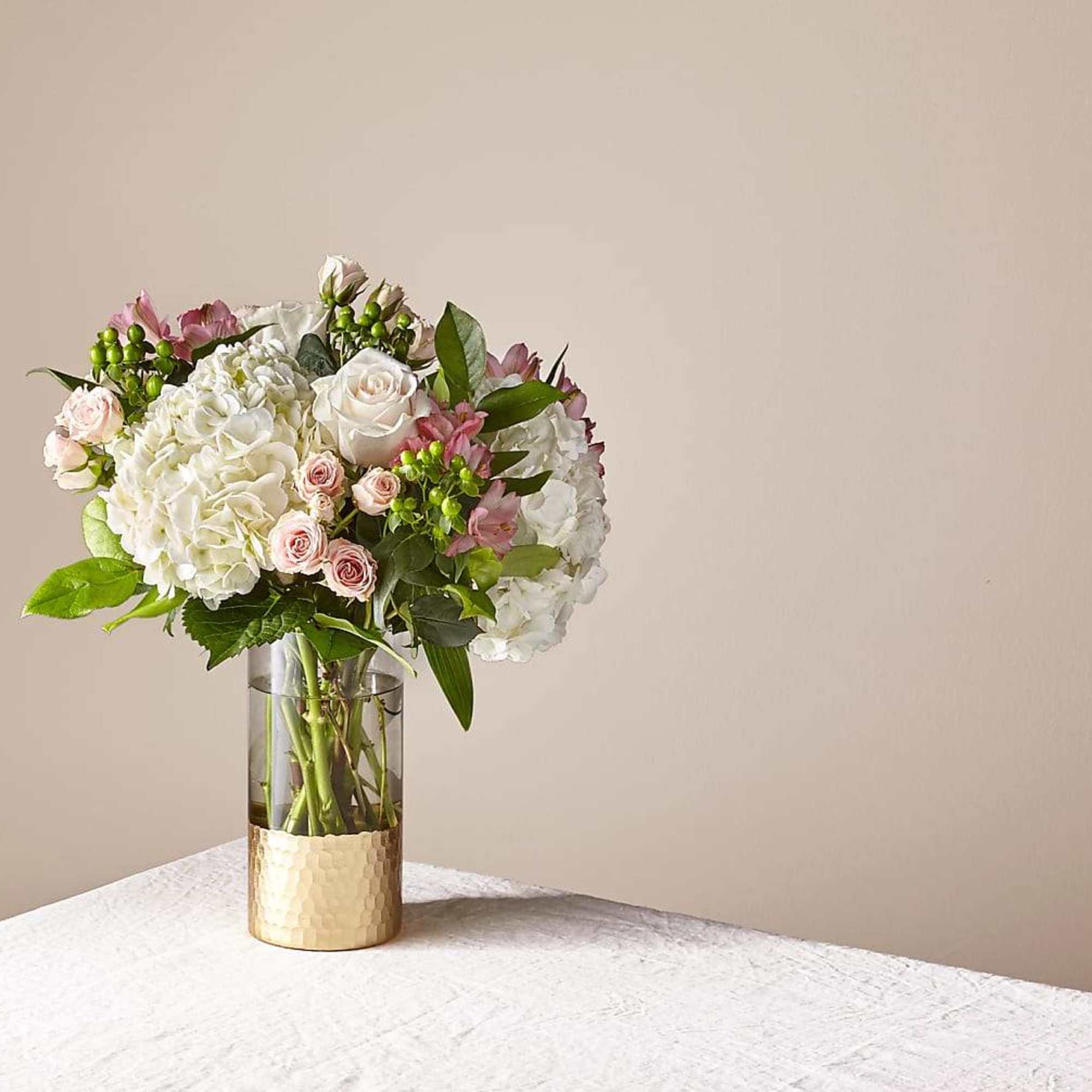 Bouquet of white and pale pink flowers in a glass vase