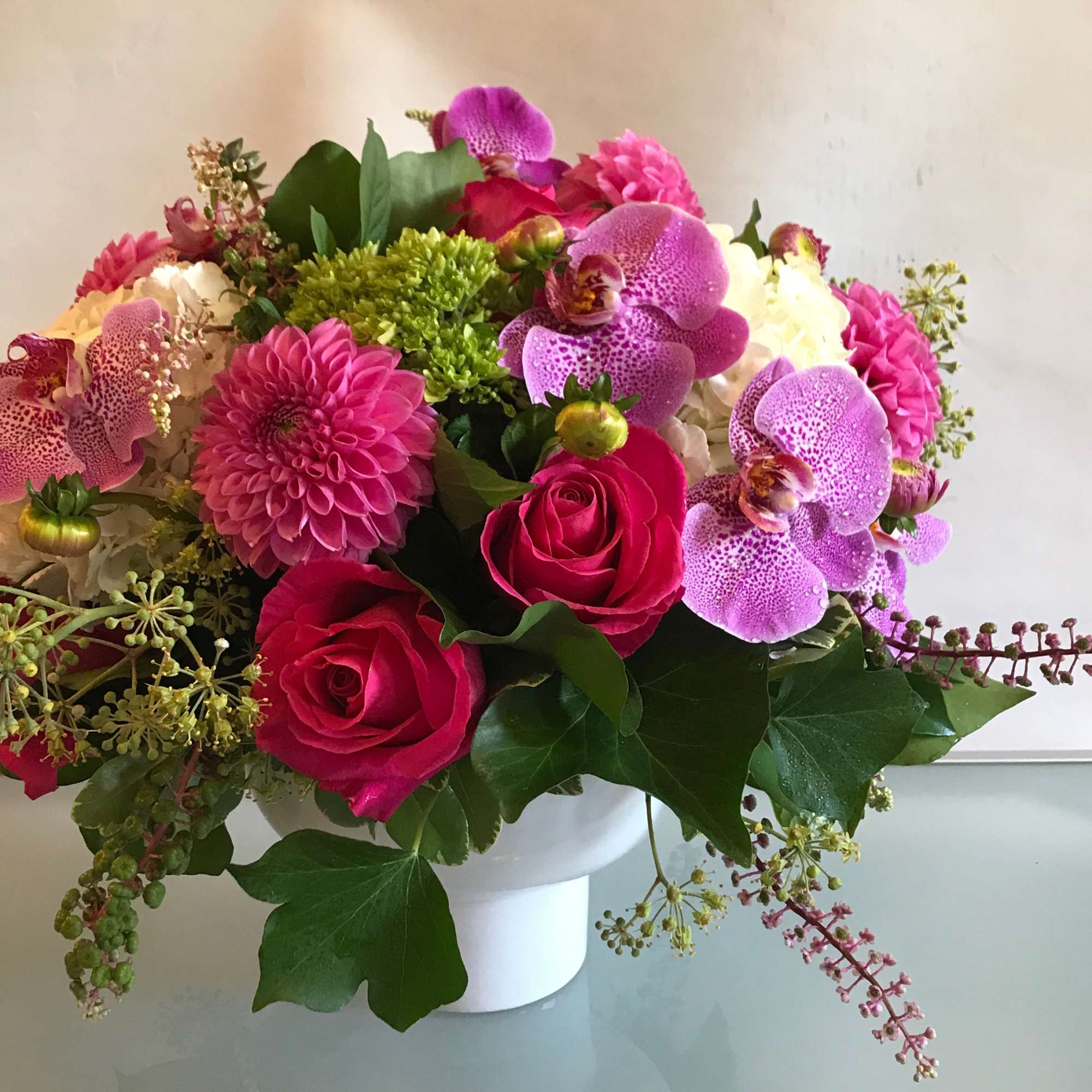 Pink and purple mixed bouquet in a white vase