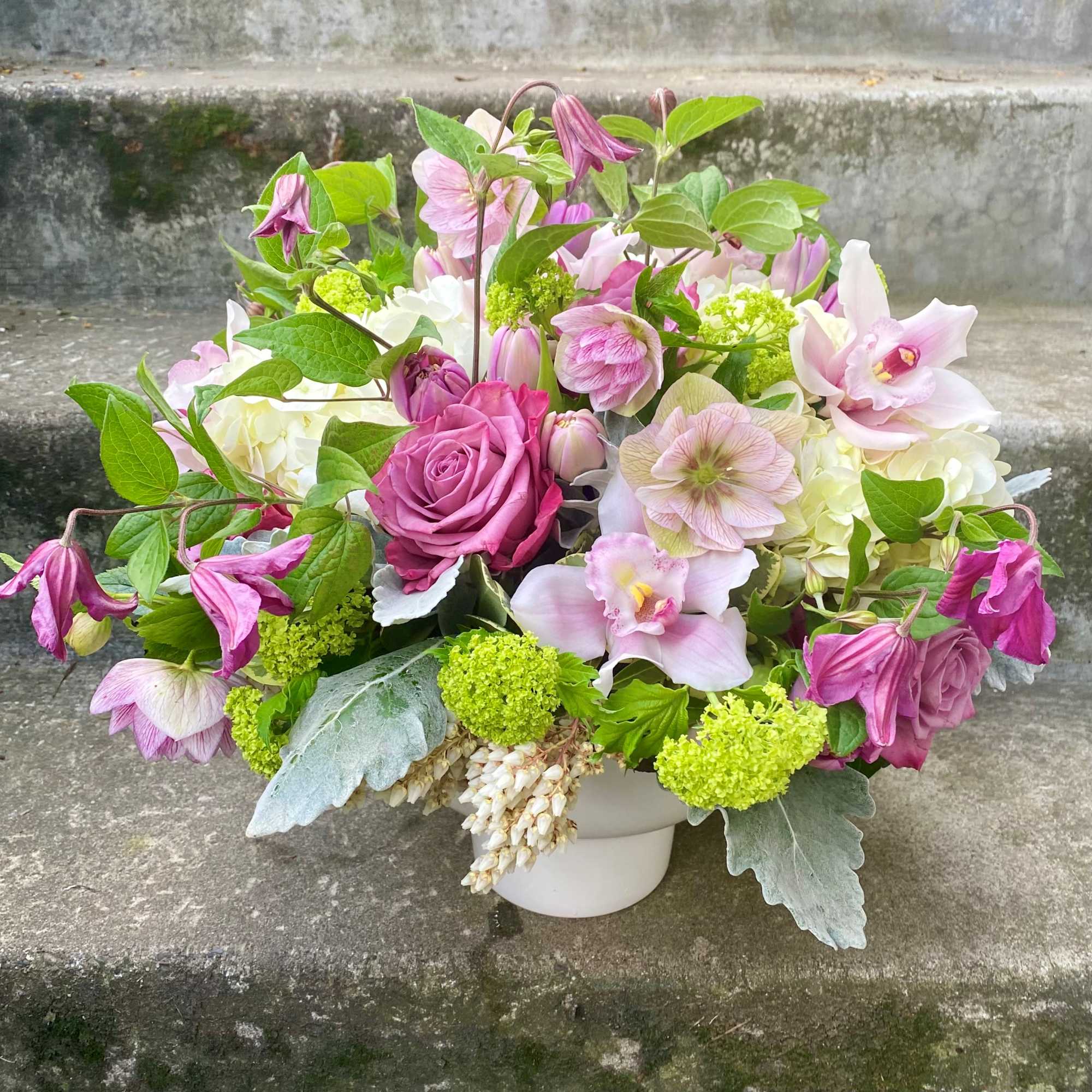 Pink and white floral arrangement in a white vase