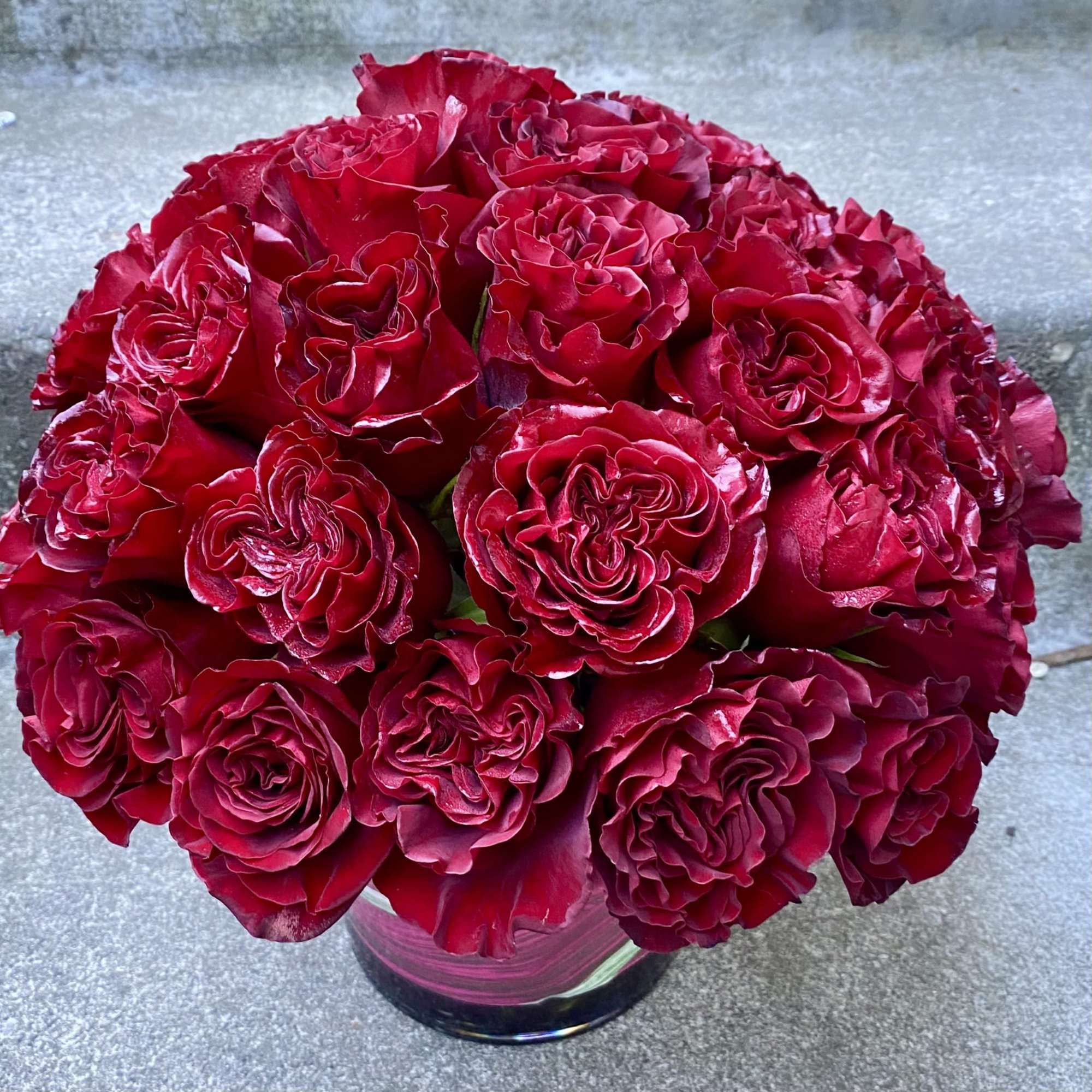 Bouquet of deep red roses in a clear glass vase