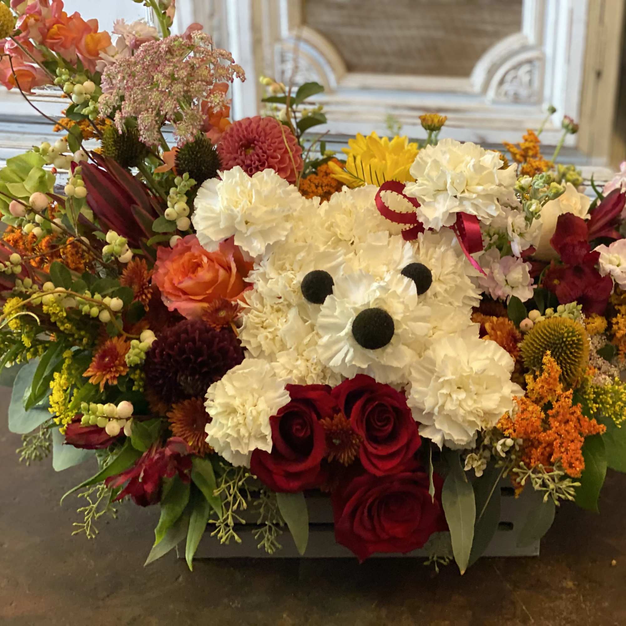 Colorful floral arrangement with a teddy bear made of white flowers and red roses