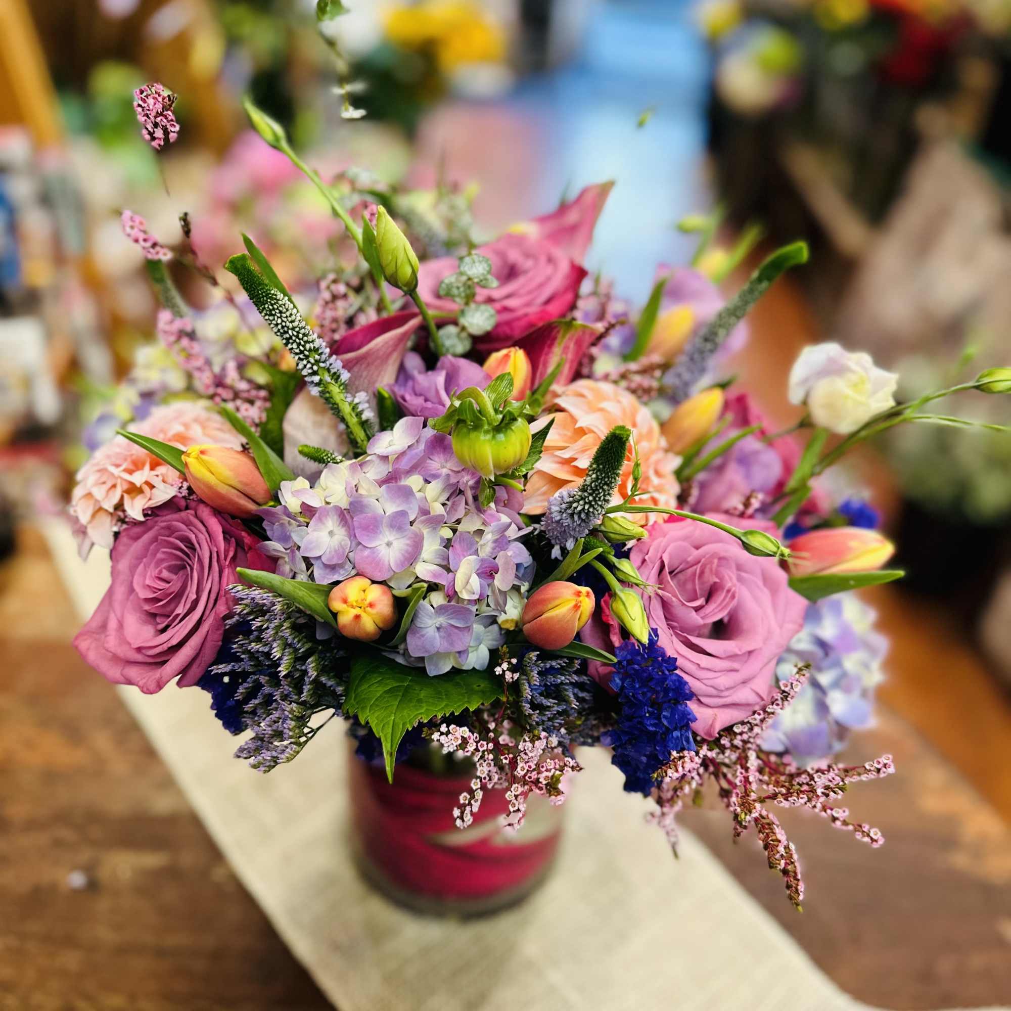 This lovely arrangement comes in a low cylinder vase with vibrant tulips
