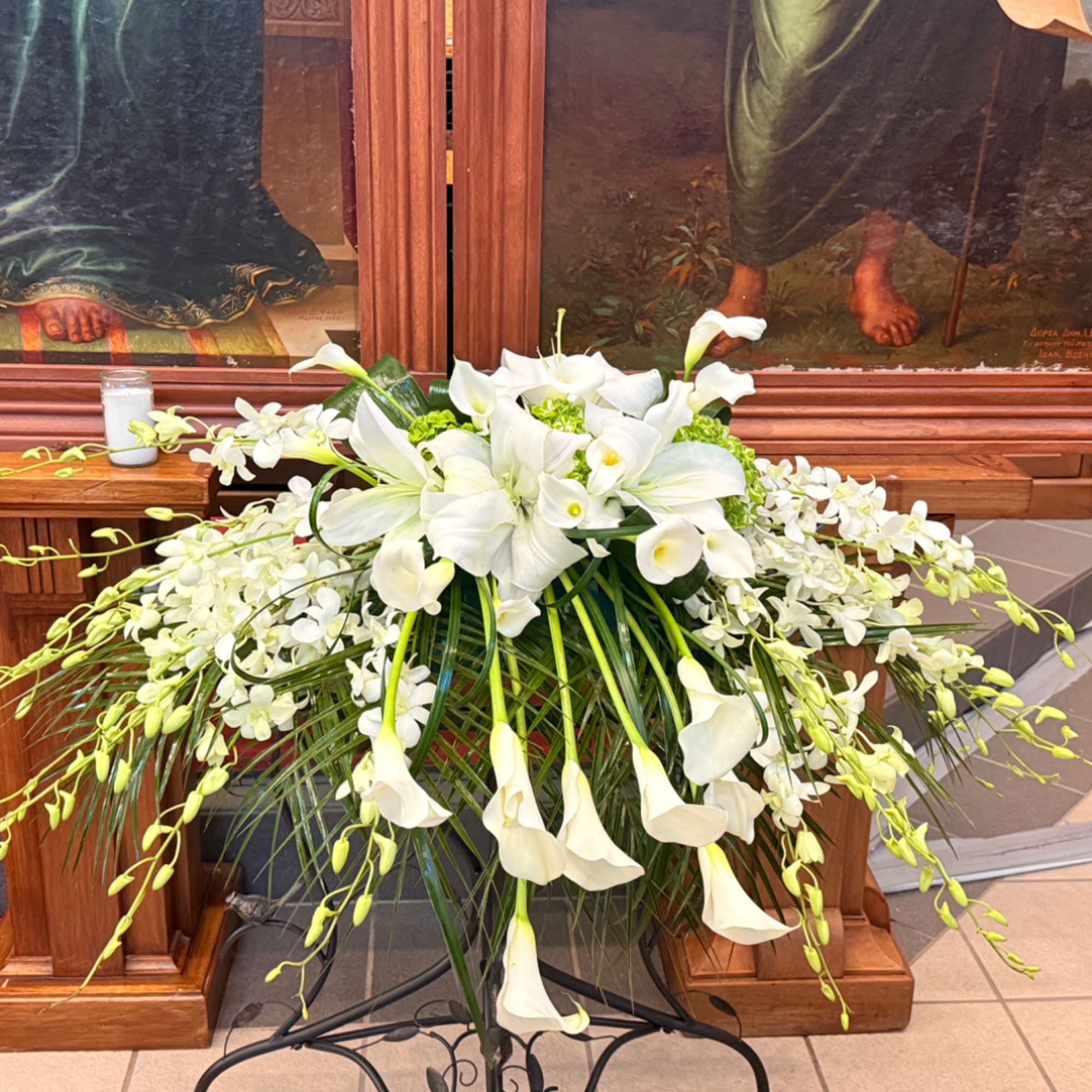 White lilies and calla lilies arranged in a large standing display