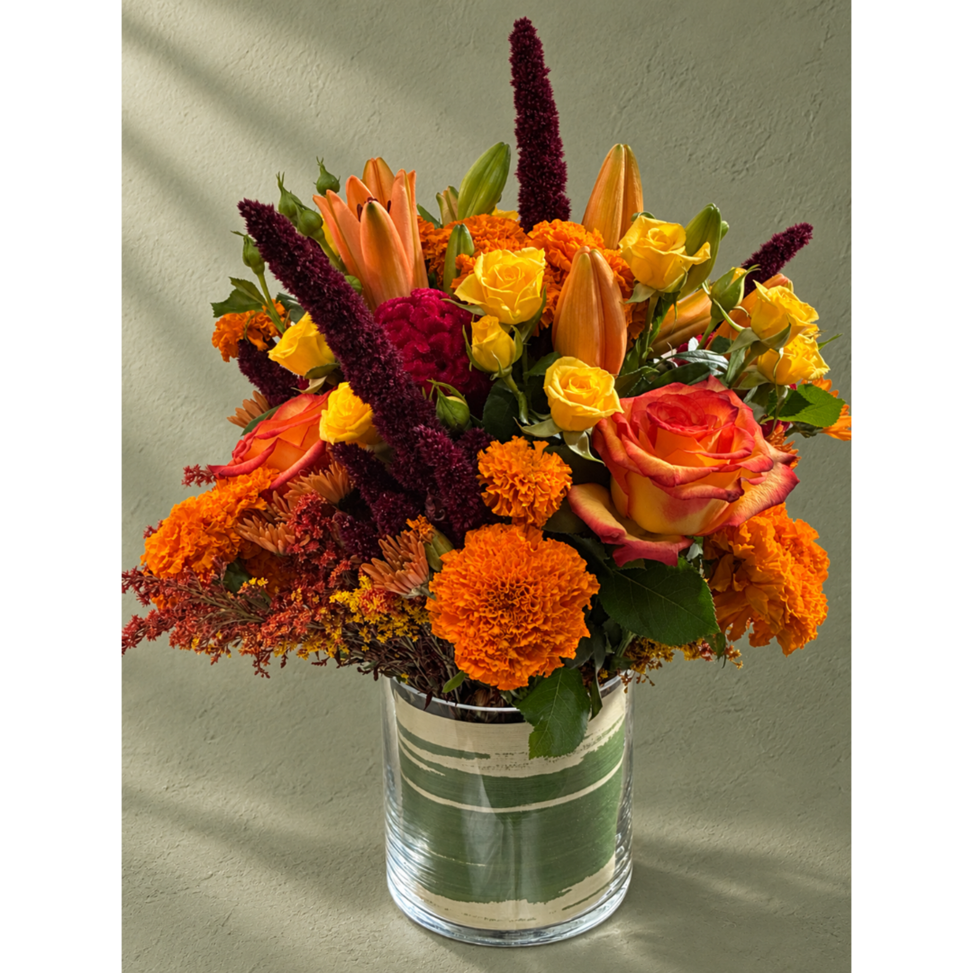 Orange and yellow mixed bouquet in a clear glass vase