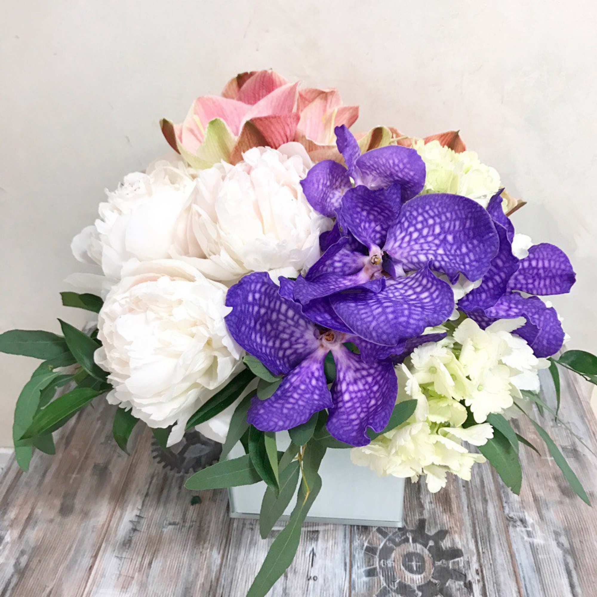 Bouquet of white and purple flowers in a white box