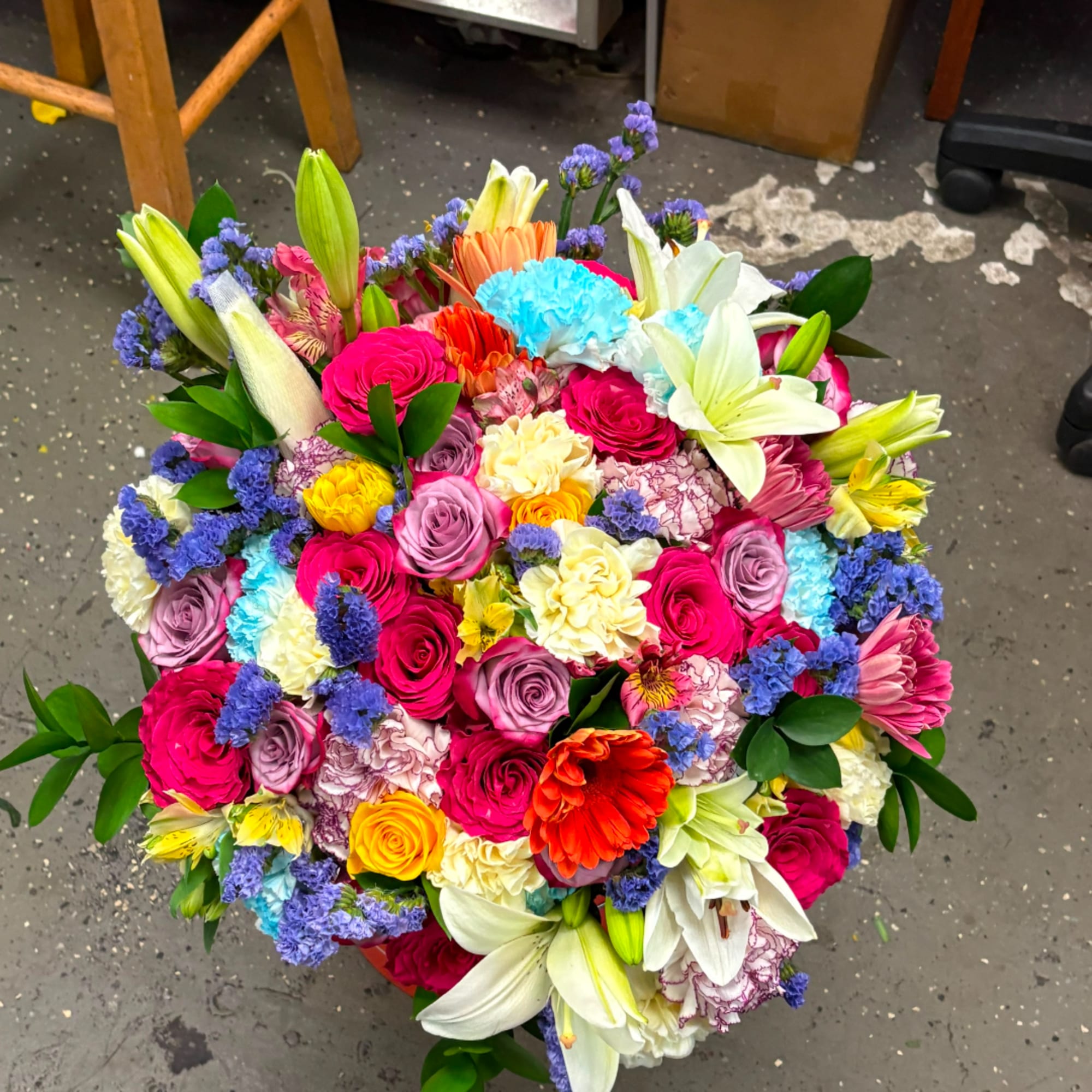 Colorful mixed bouquet with roses, lilies, carnations, and daisies