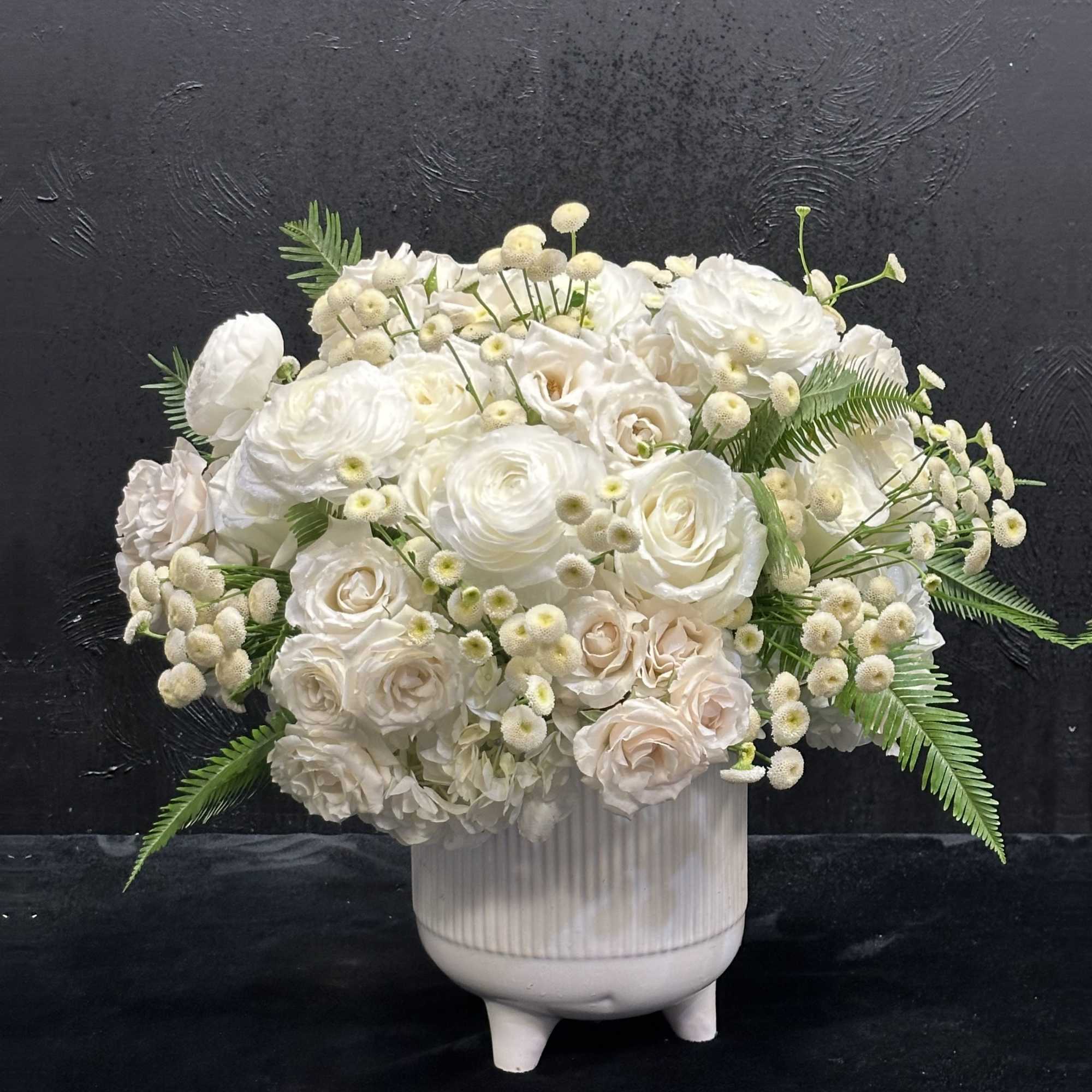 White rose bouquet in a ribbed ceramic vase