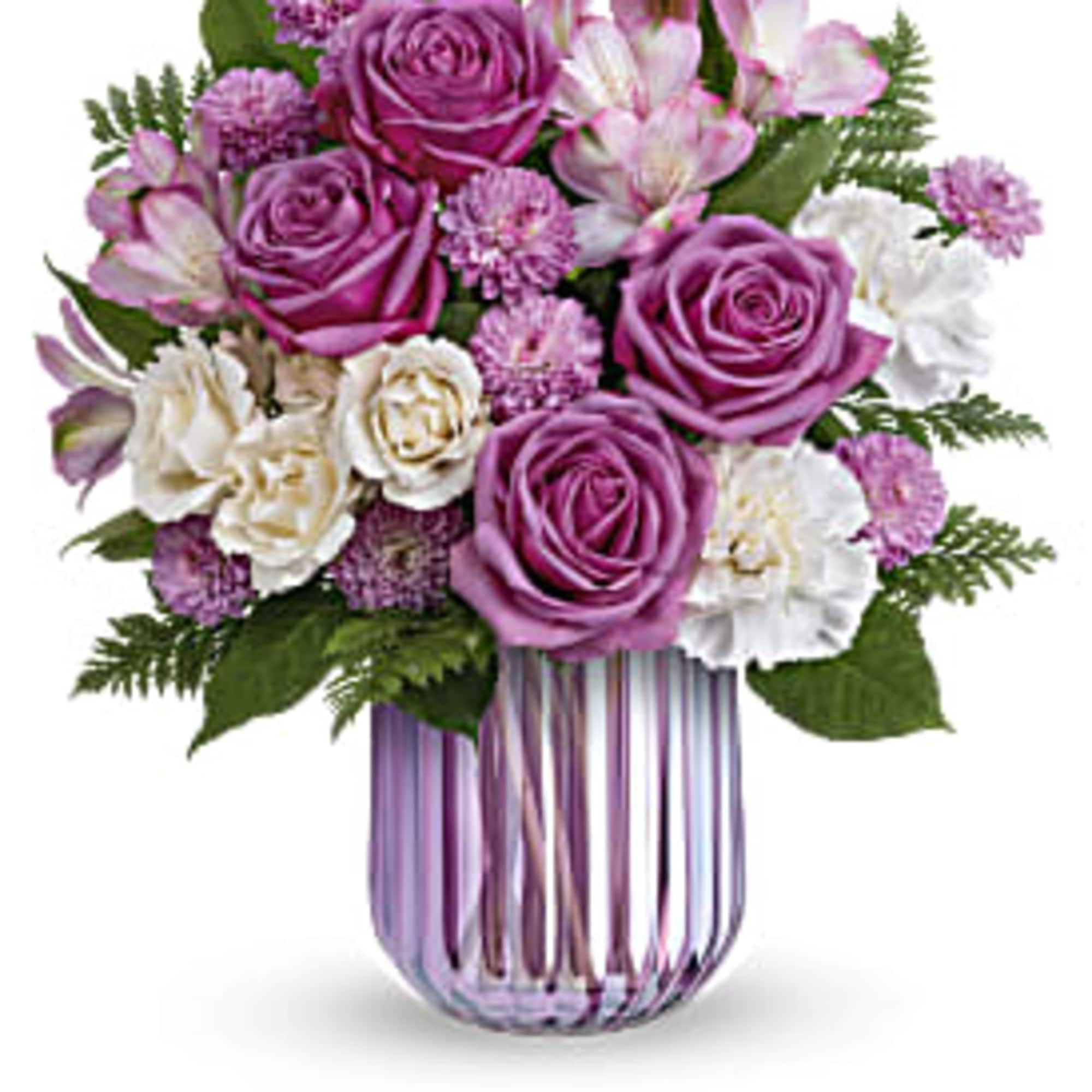 Purple and white rose bouquet in a striped glass vase
