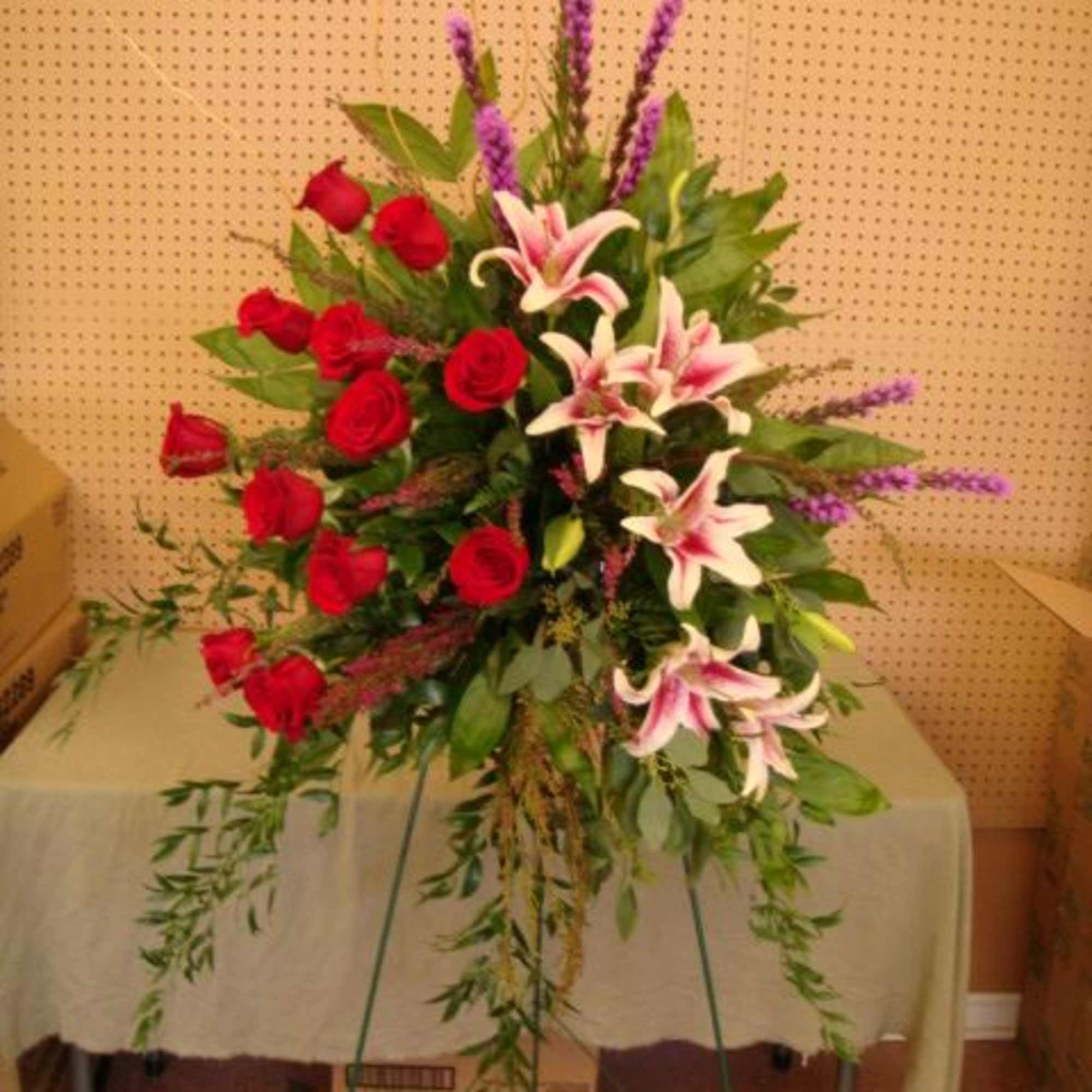 Standing floral spray with red roses and pink lilies