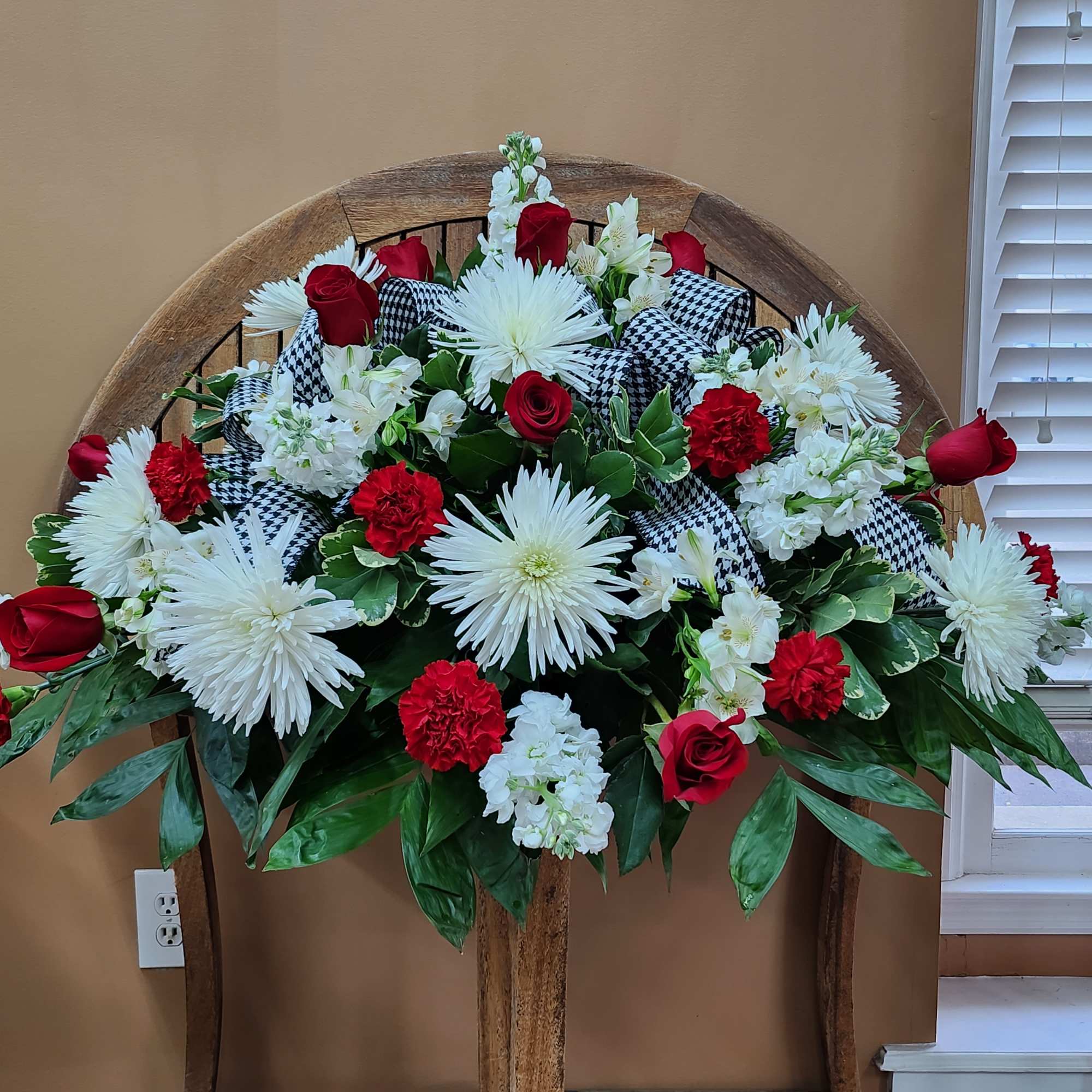 Red and white flowers with houndstooth ribbon.
