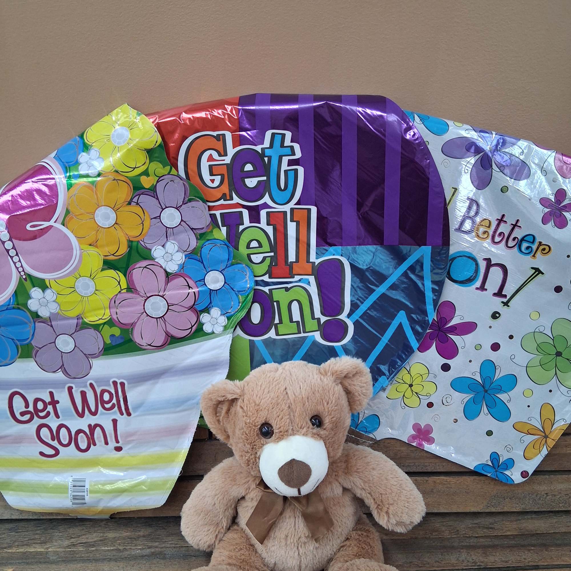 Stuffed bear with 5 assorted Get Well balloons.
Bear color will vary. Balloon