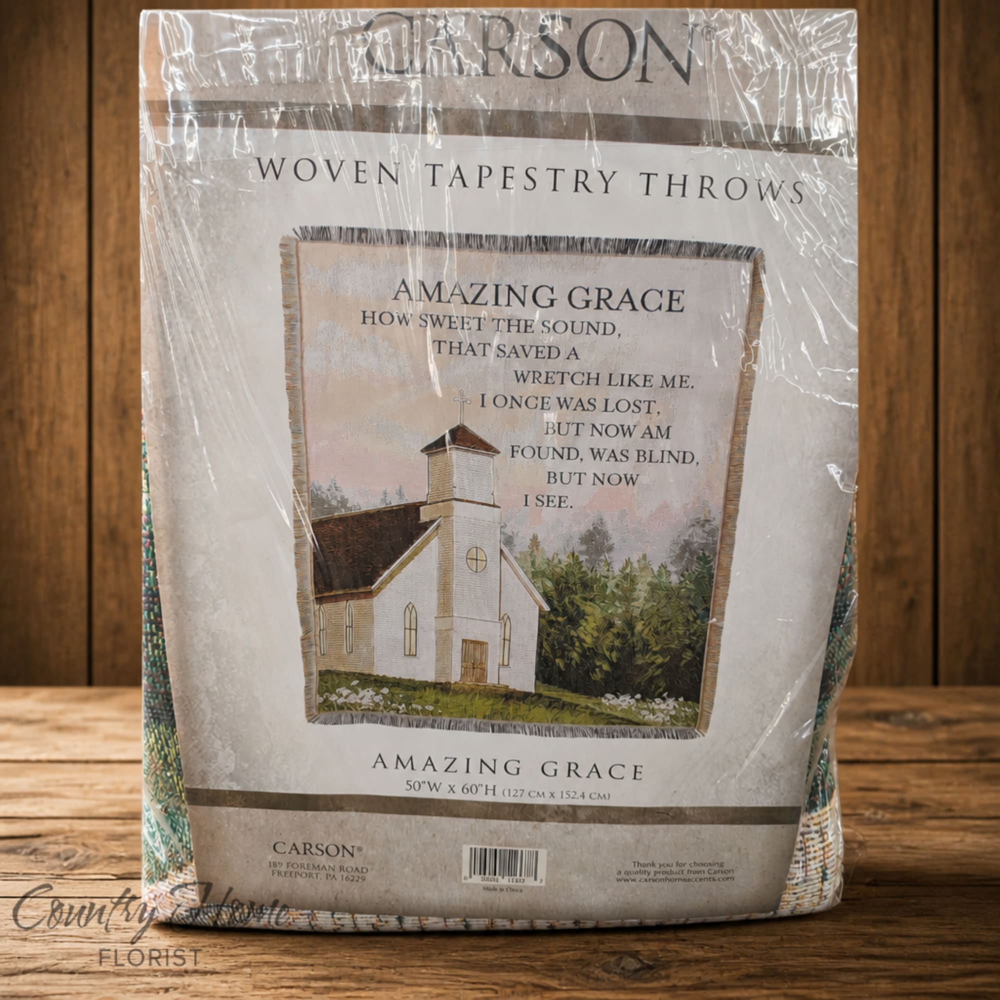 Packaged woven tapestry throw with a church and hymn text
