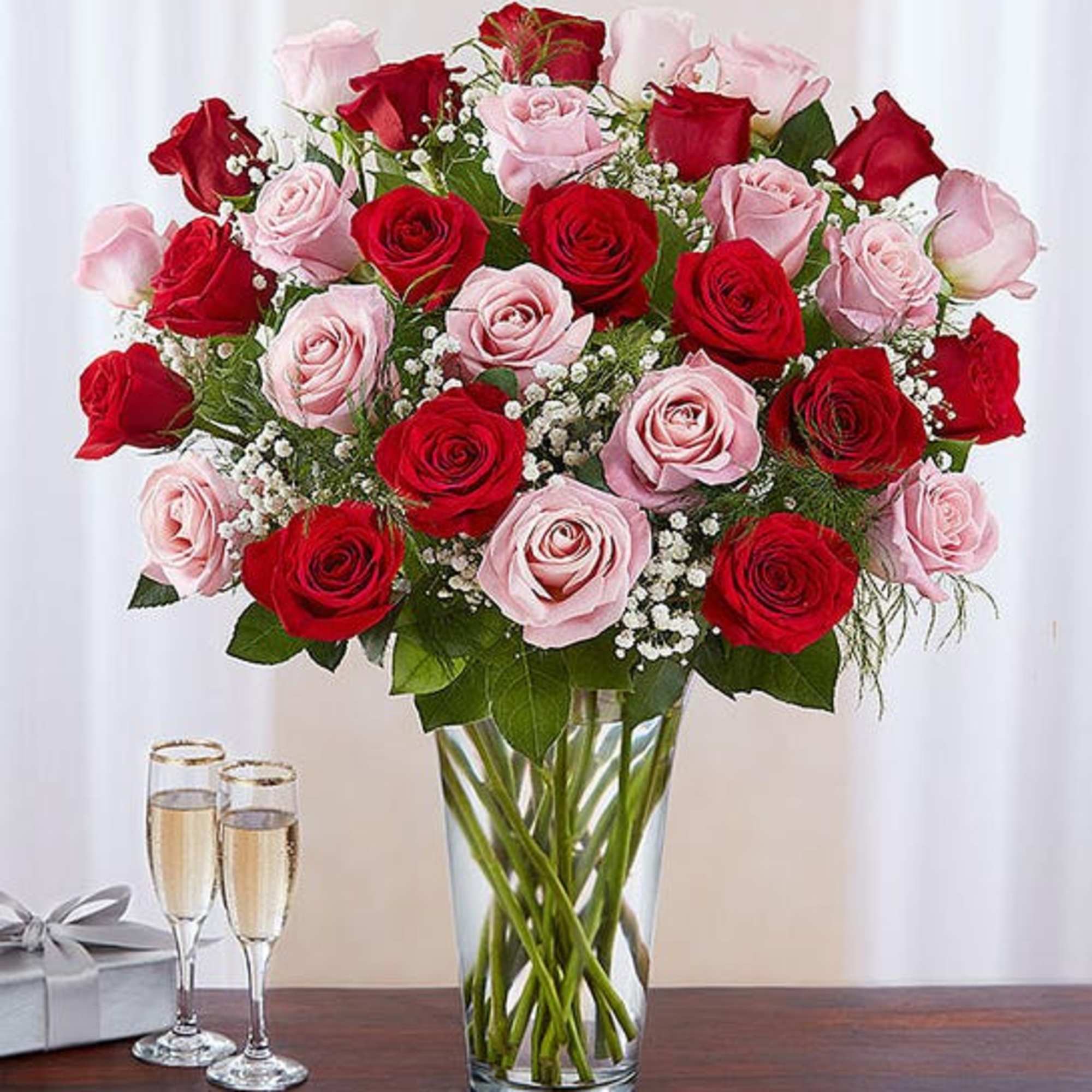 Bouquet of red and pink roses in a clear glass vase