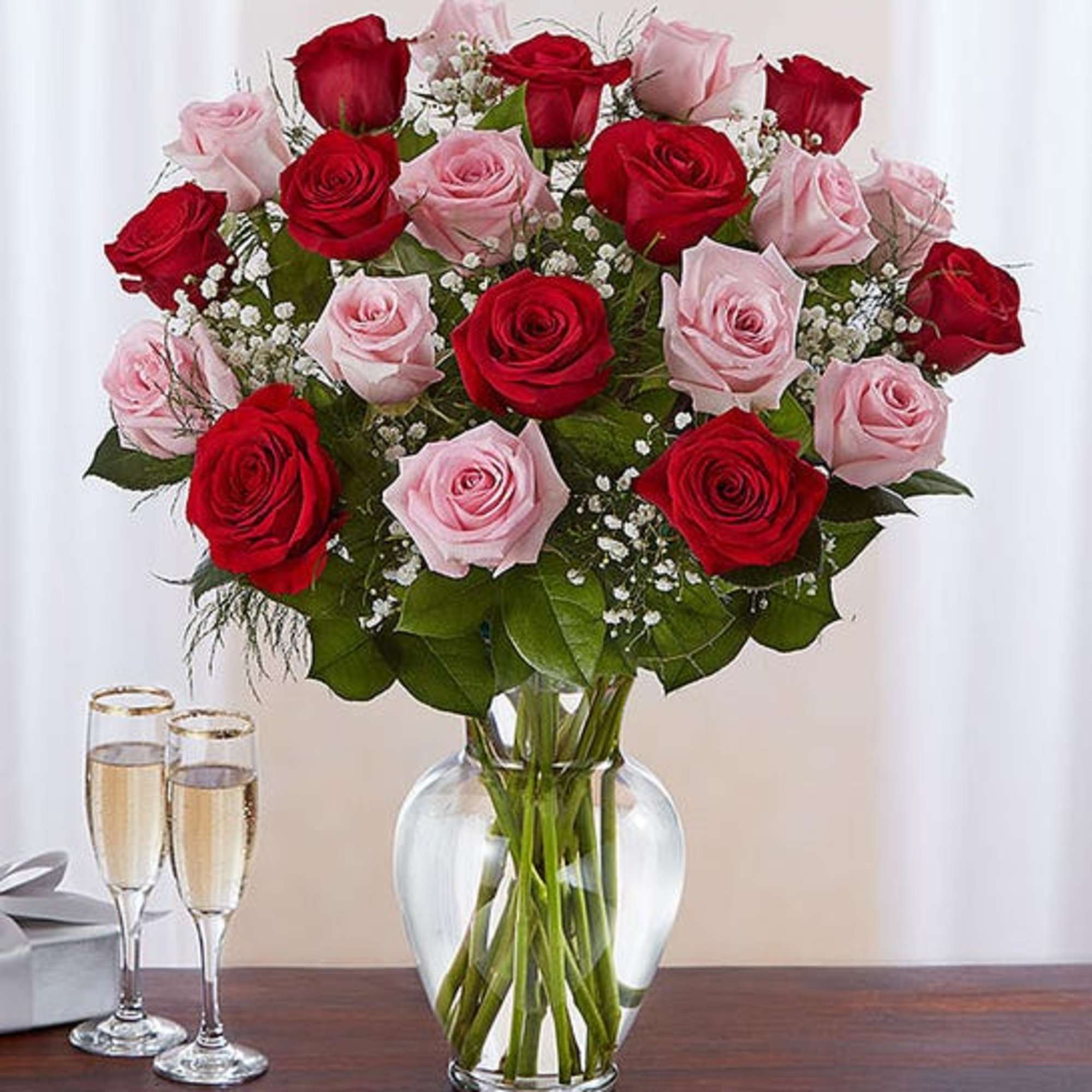 Bouquet of red and pink roses in a clear glass vase