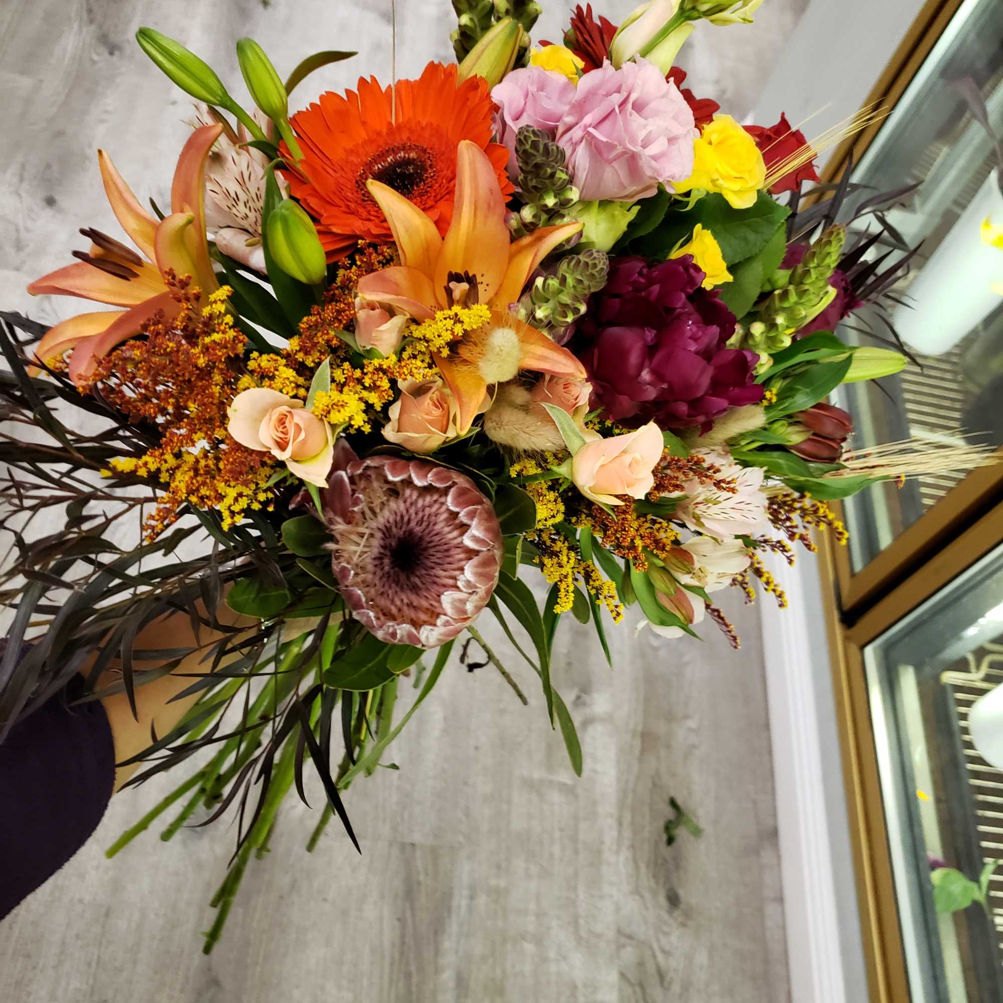 Mixed bouquet with orange lilies, gerbera daisies, and pink blooms