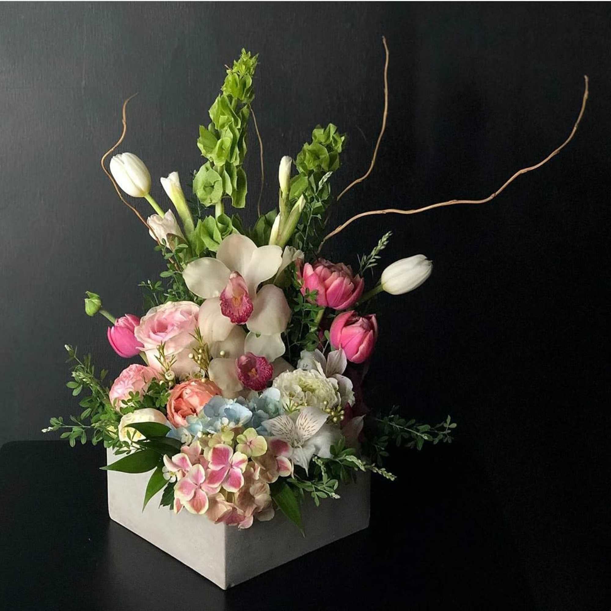 A vertical design with seasonal spring flowers in pastel mix Flowers may