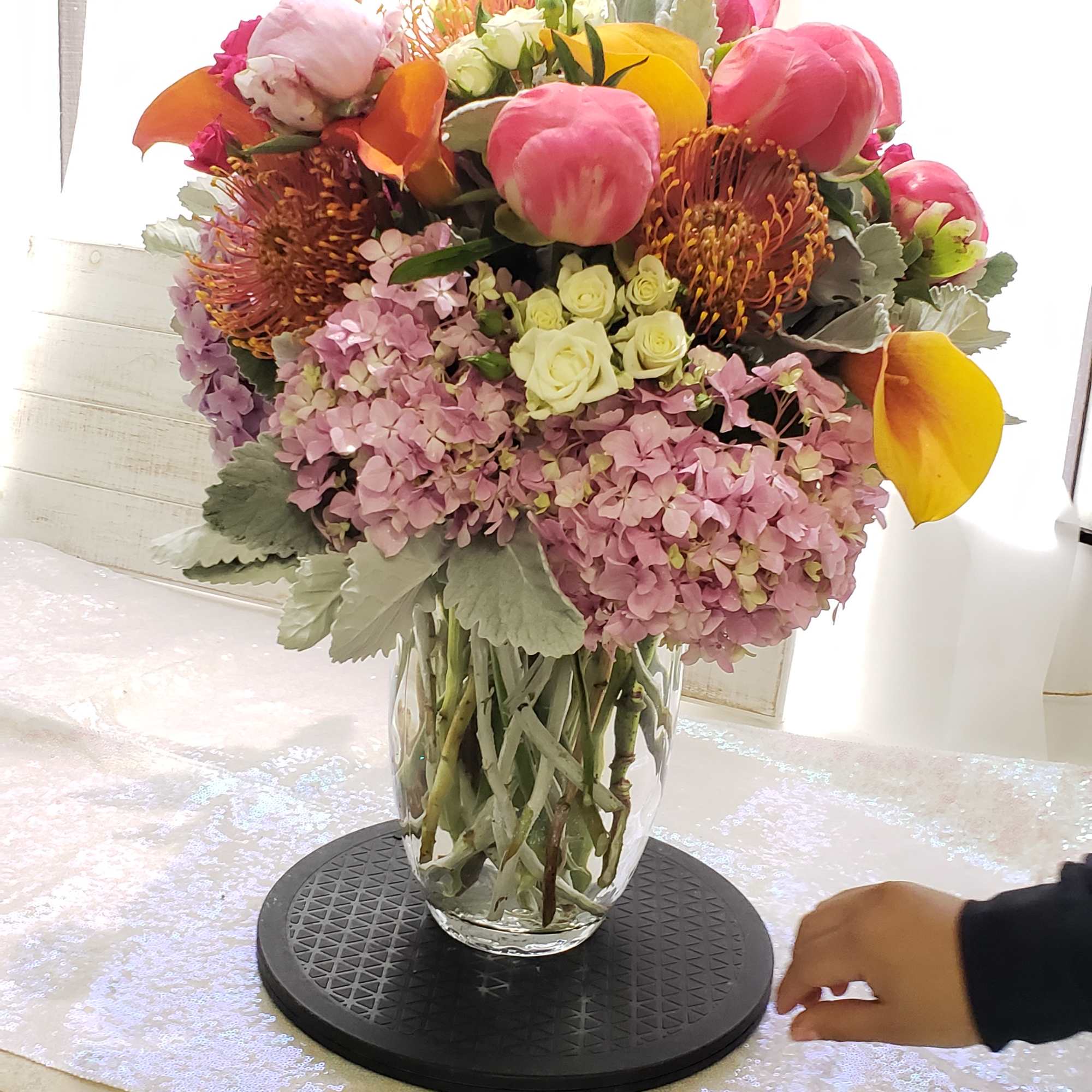 Pink and orange mixed bouquet in a clear glass vase