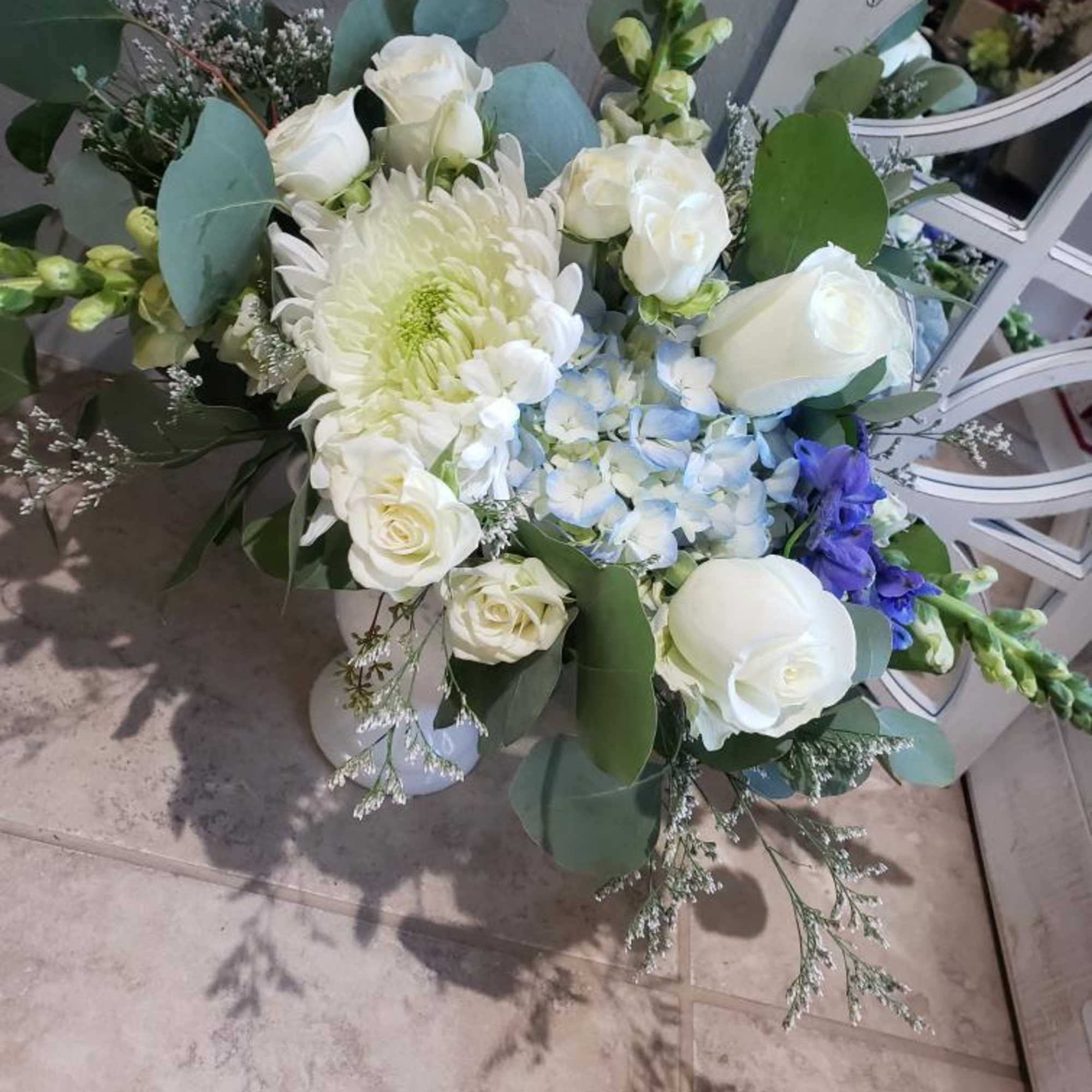 White and blue floral bouquet with roses and hydrangea