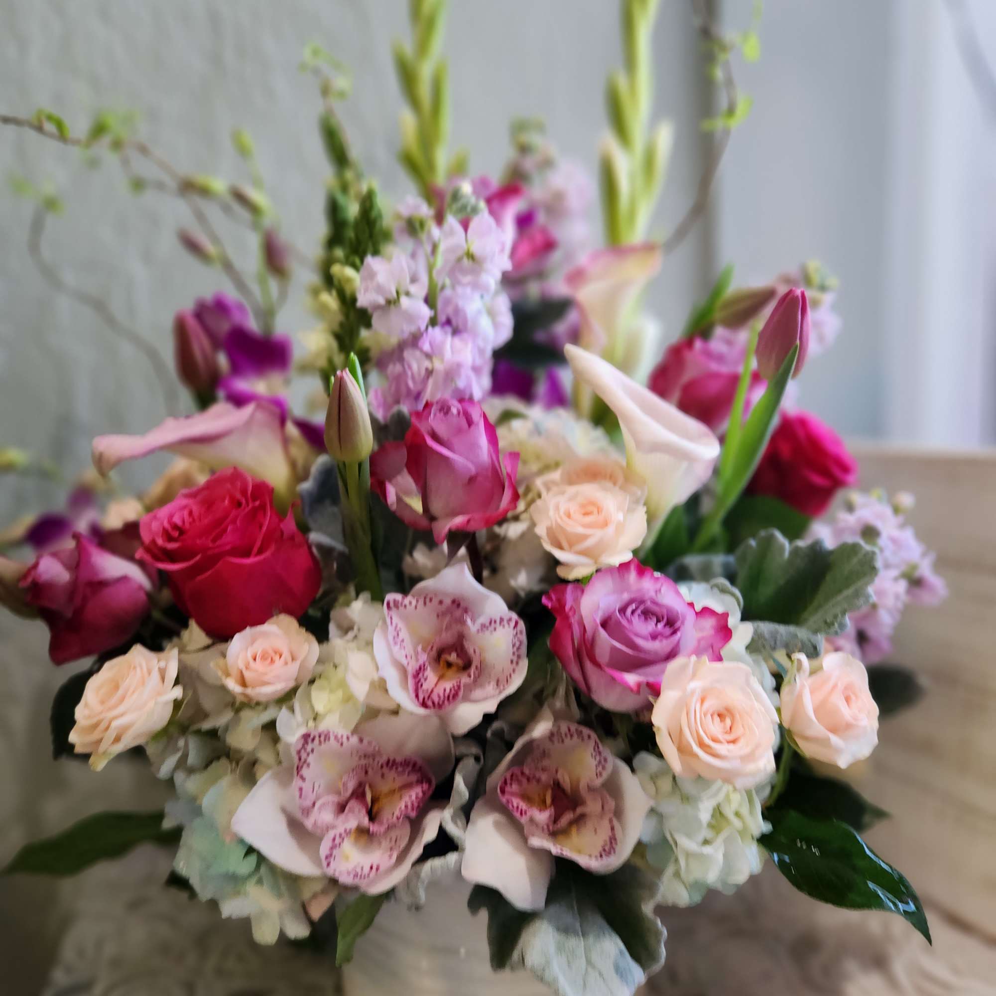 A vertical design with seasonal spring flowers in pastel mix Flowers may