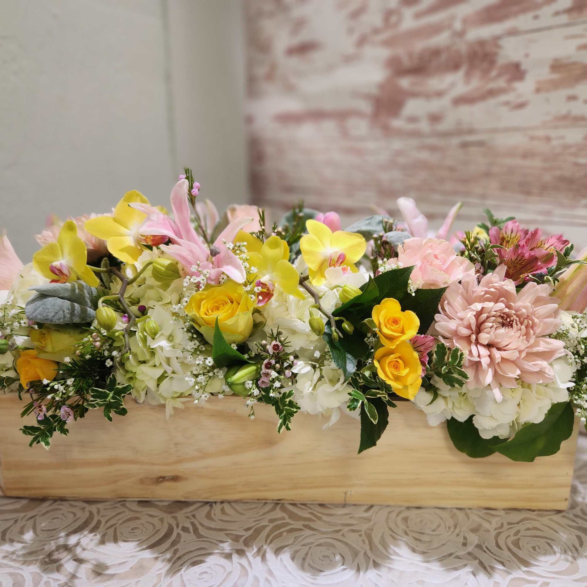 A beautiful low and low style arrangement designed in a wood box