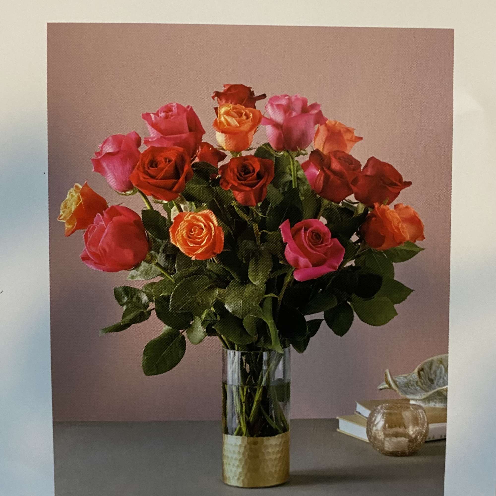 Bouquet of multicolored roses in a clear glass vase