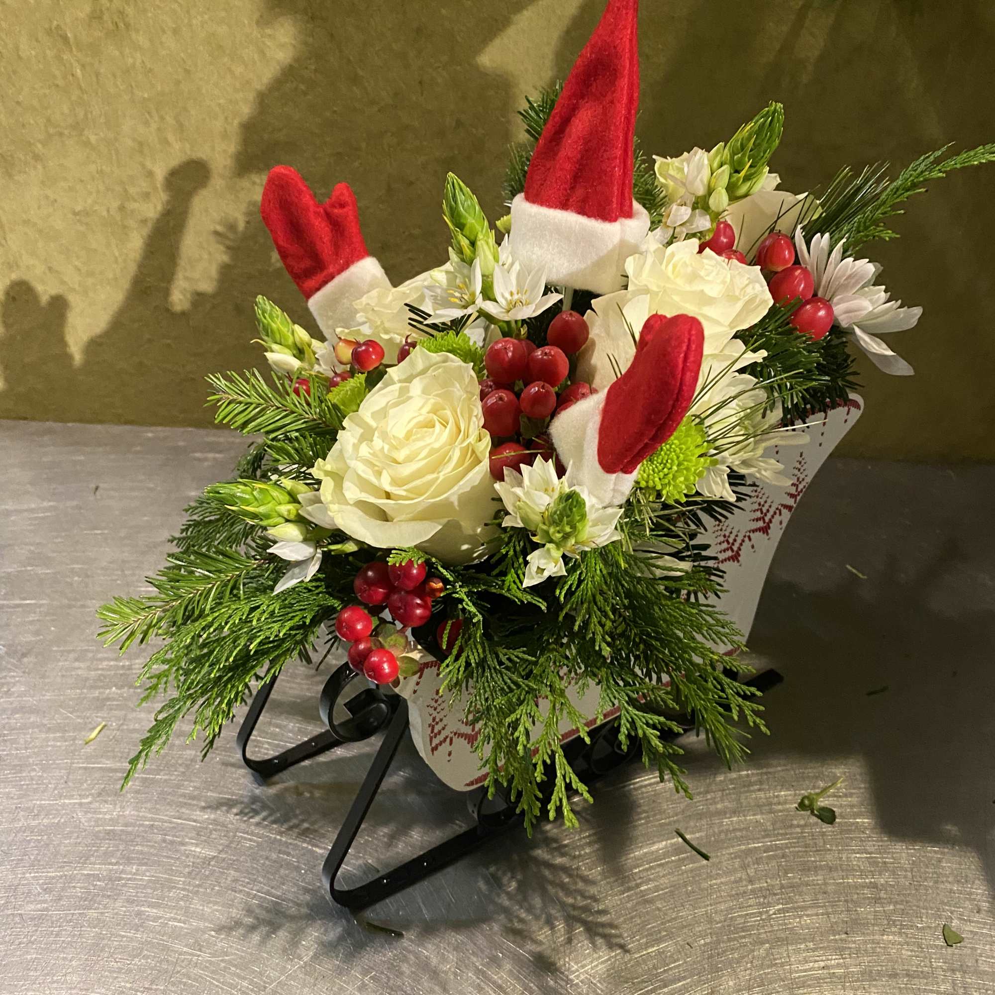 Christmas bouquet with white roses, red berries, and Santa hat picks