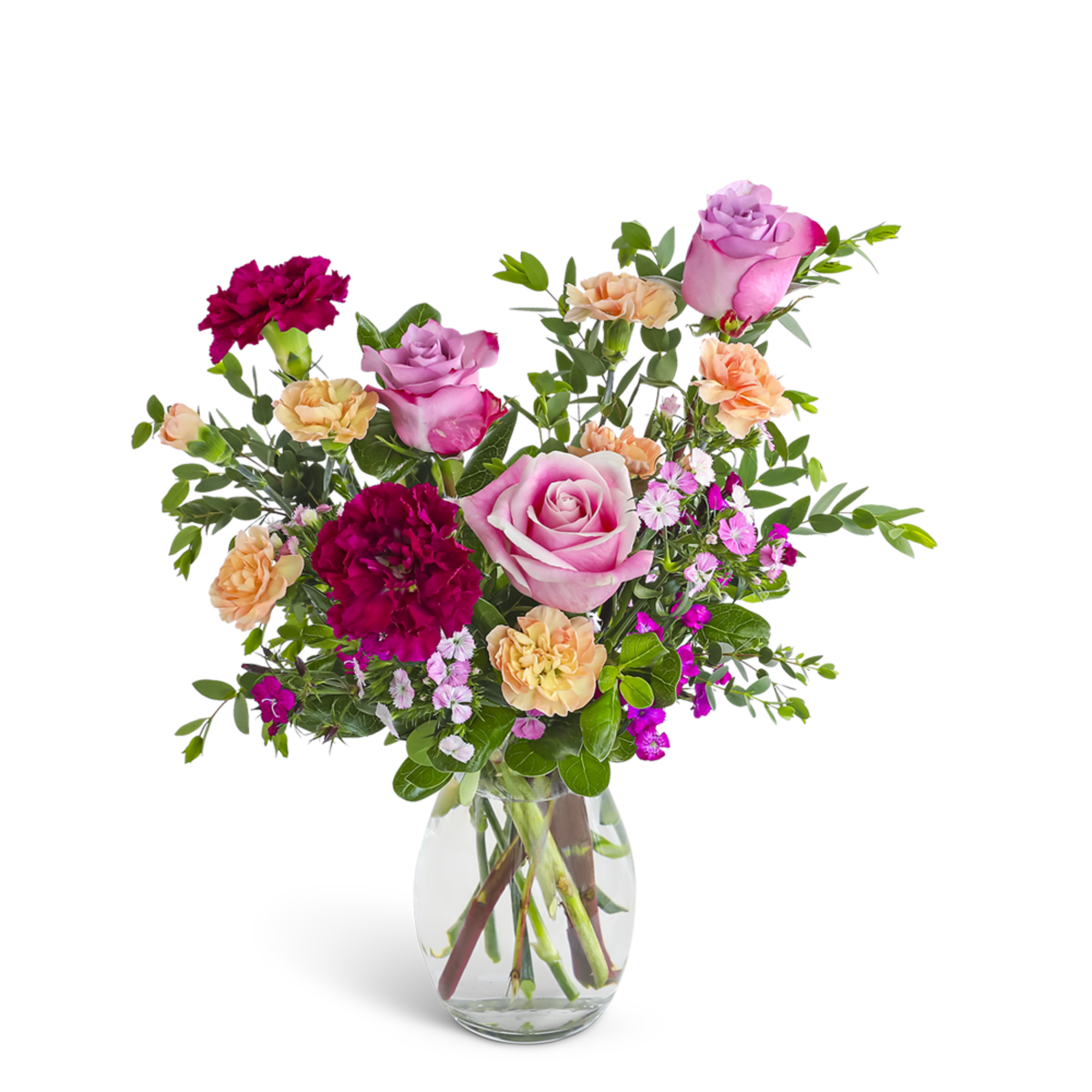 Mixed bouquet of pink roses, red and peach carnations, and pink dianthus in a clear glass vase