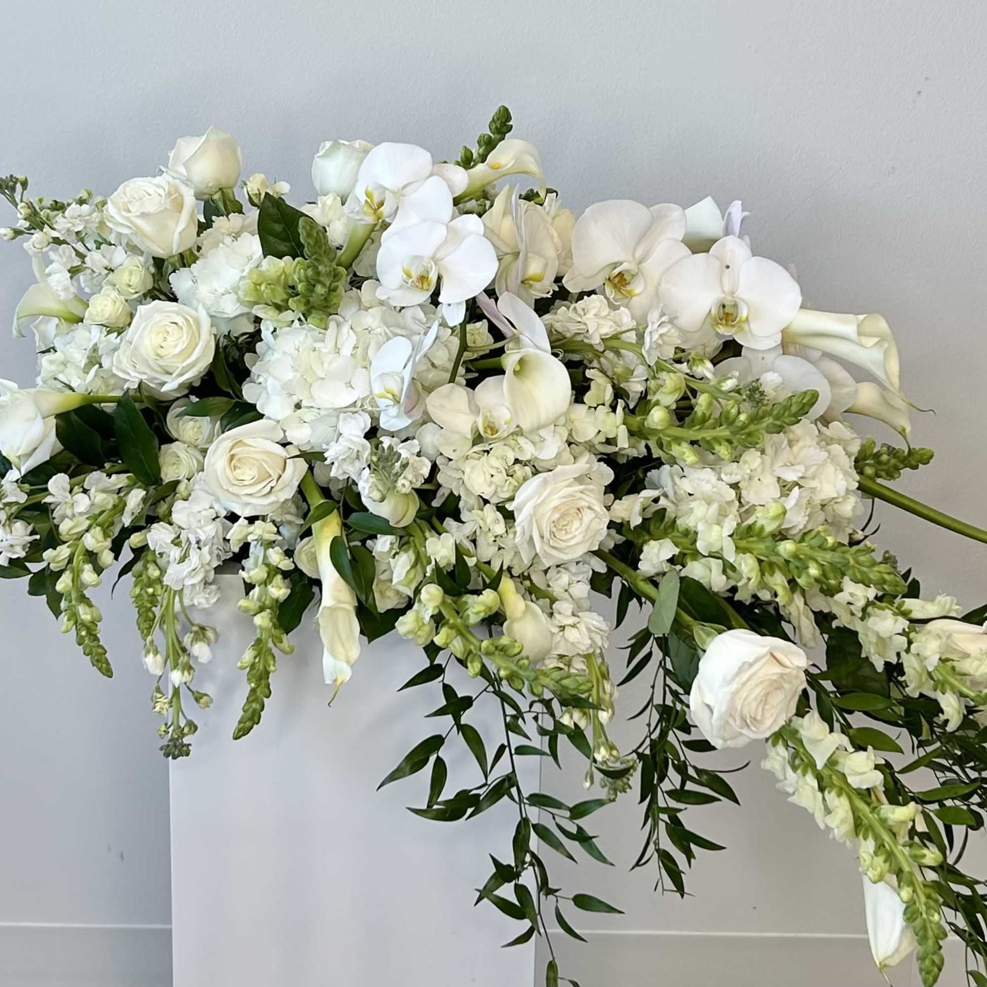 White floral arrangement with roses, orchids, and calla lilies, photo 3 of 3