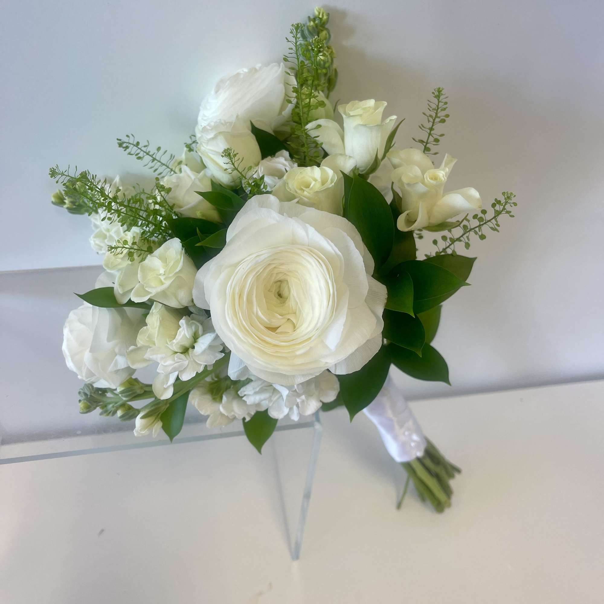White bridal bouquet with roses and ranunculus