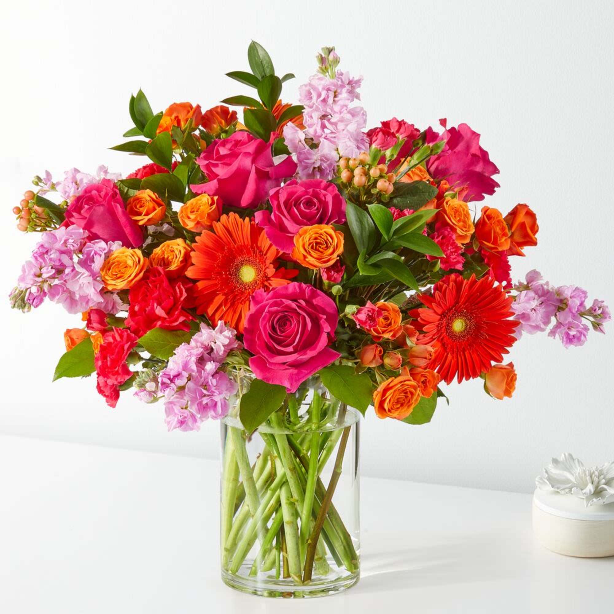 Bouquet of pink and orange flowers in a clear glass vase
