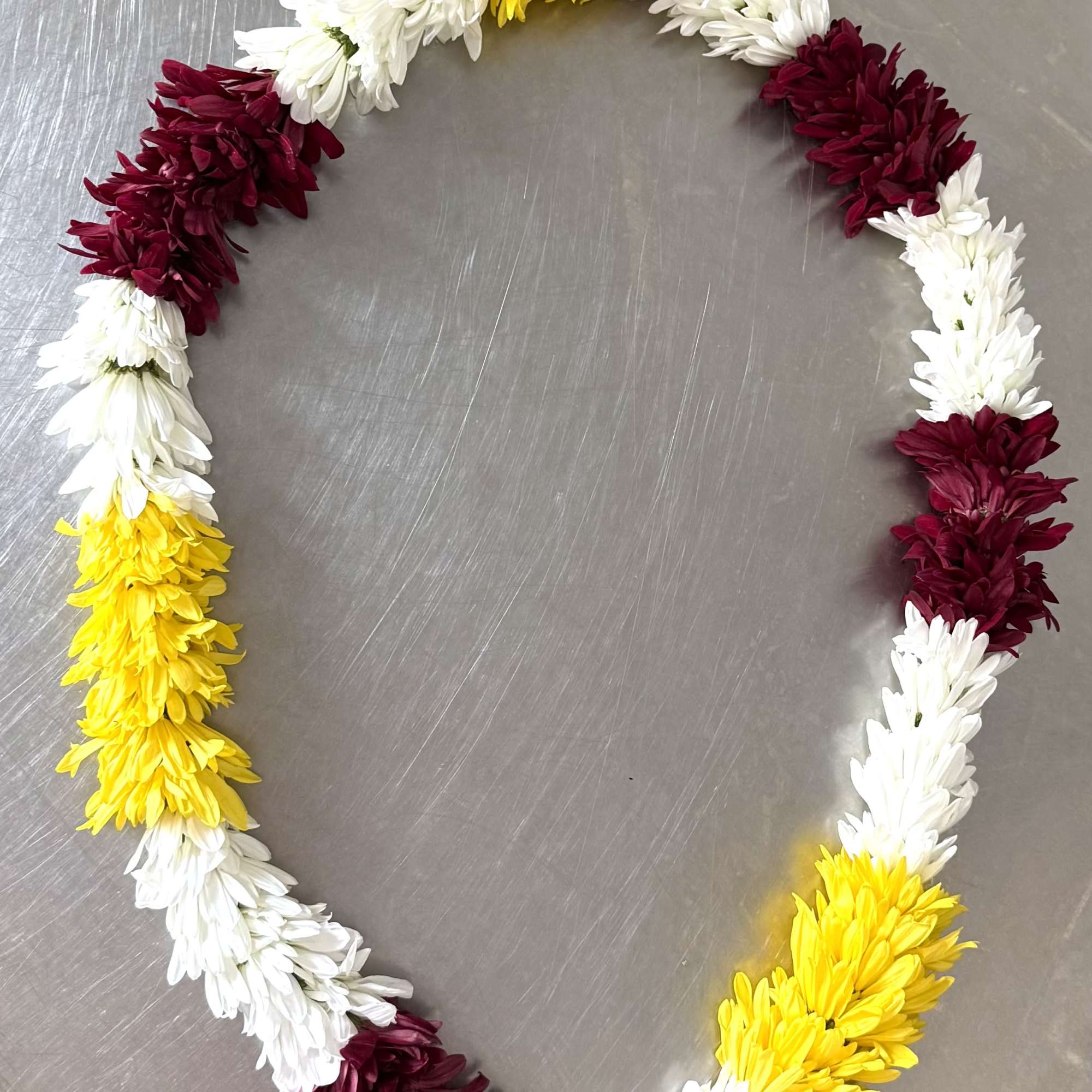 A full, rounded lei handcrafted with alternating sections of fresh white and, photo 3 of 3