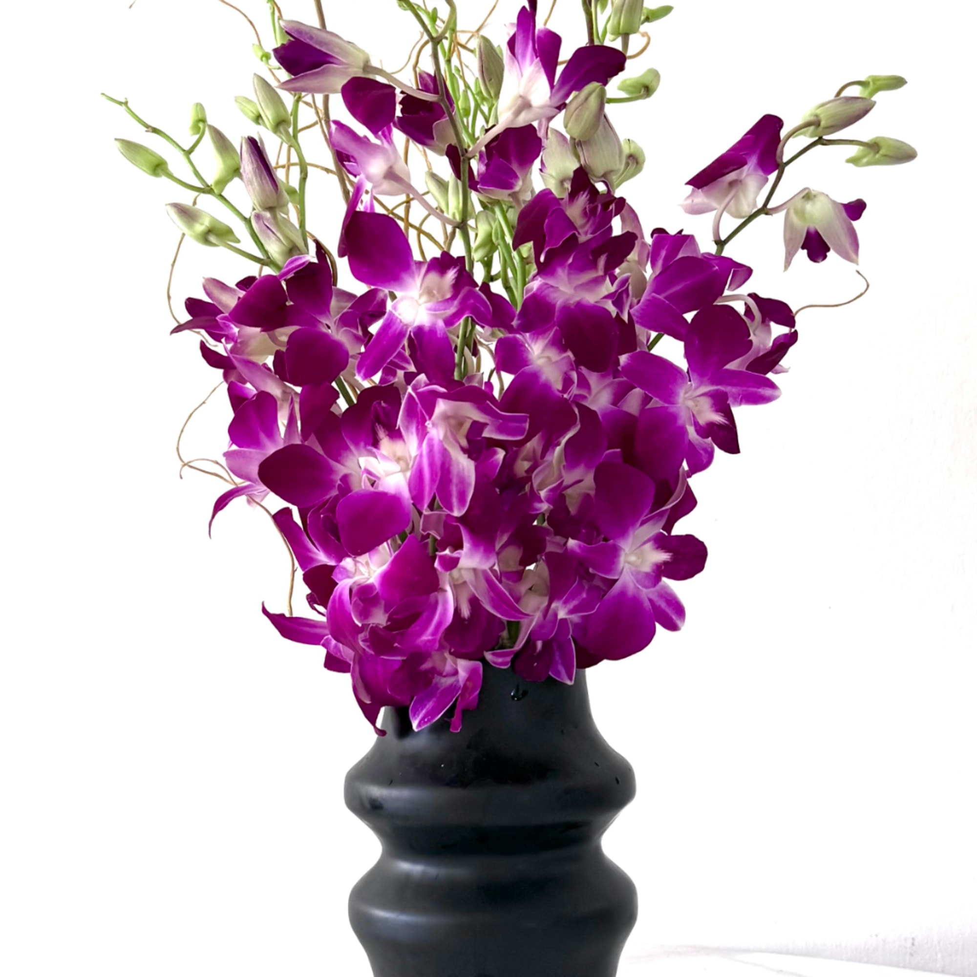 Purple orchids arranged in a black vase, photo 2 of 2