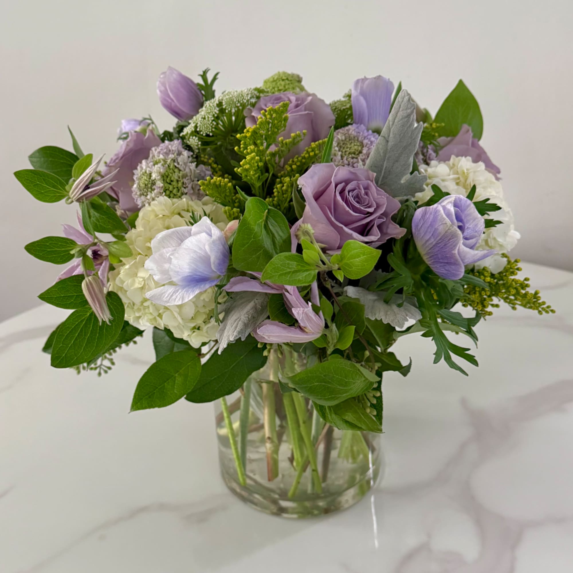 Lavender and white bouquet in a clear glass vase