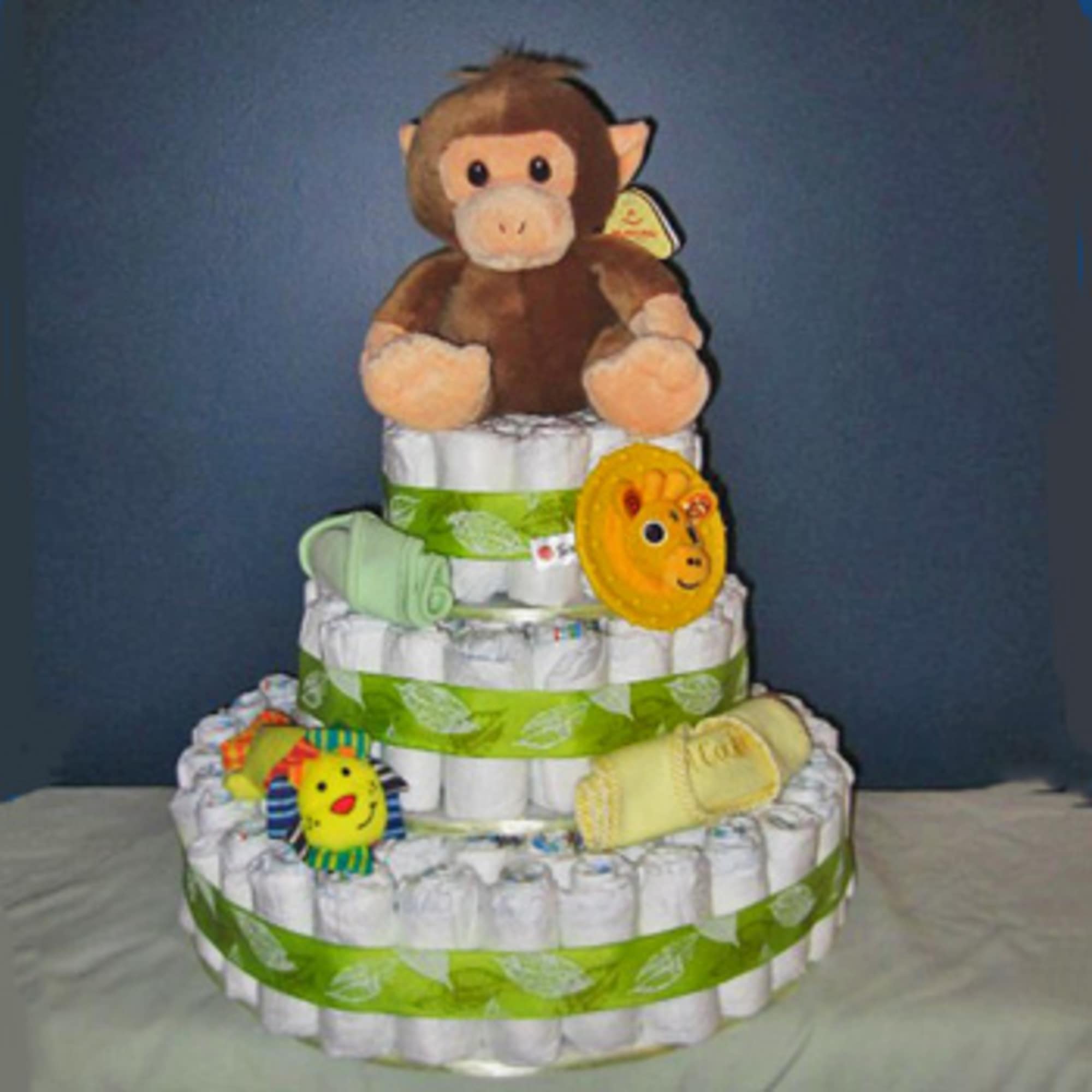 Tiered diaper cake with a plush monkey on top and baby accessories