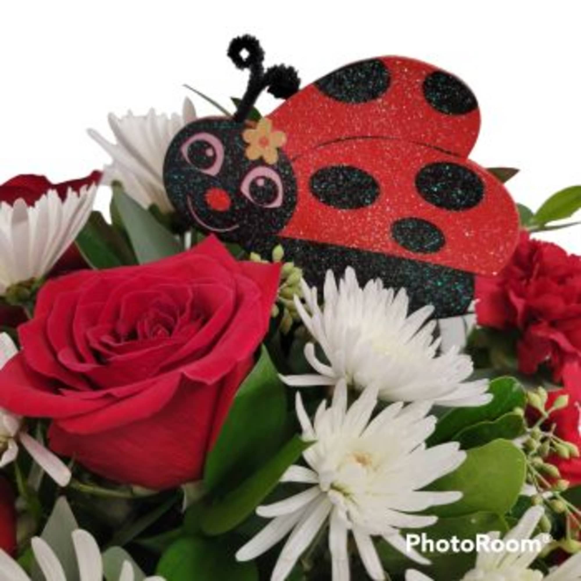 Bouquet with a red rose, white daisies, and a glittery ladybug decoration