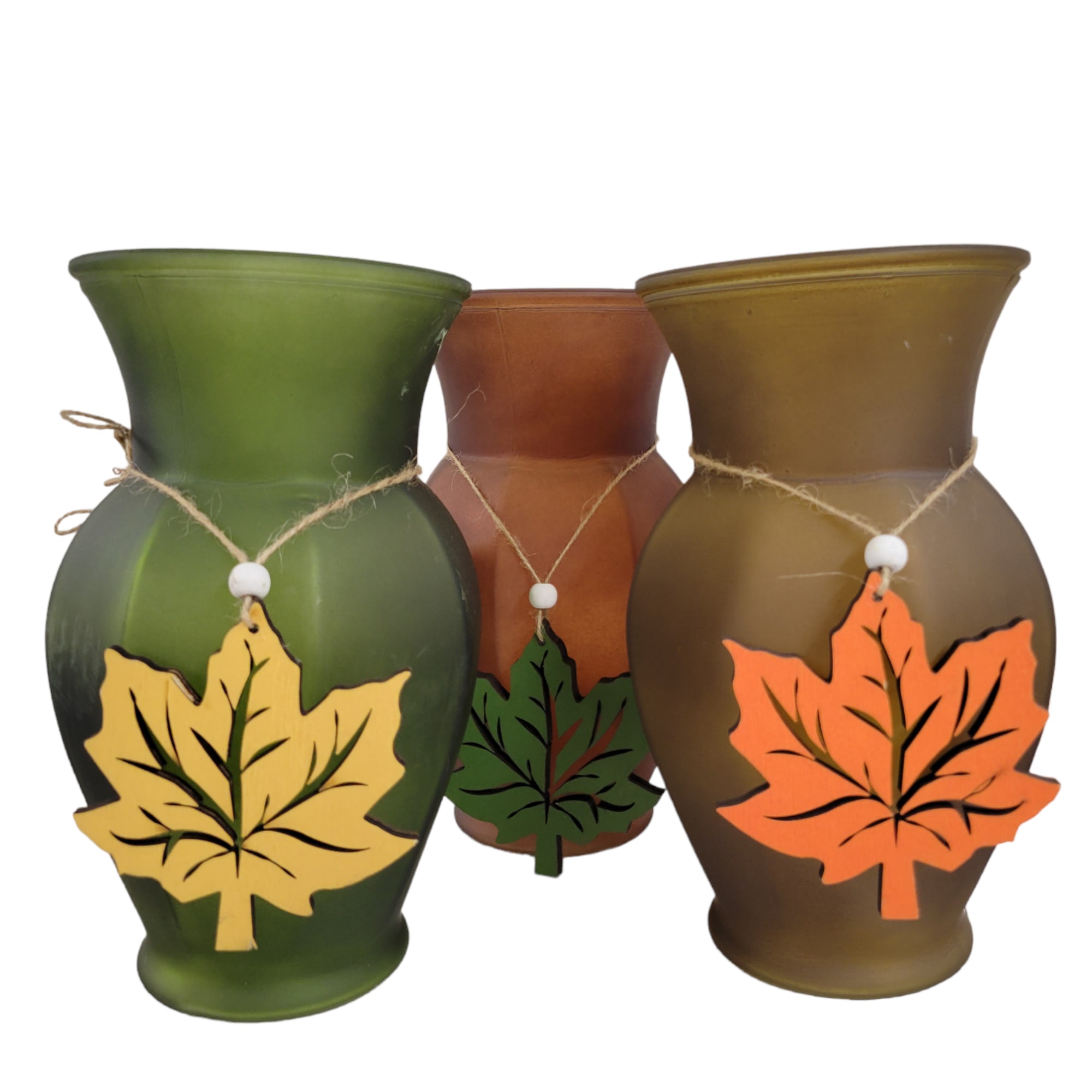 Three decorative vases with leaf ornaments in green, brown, and gold