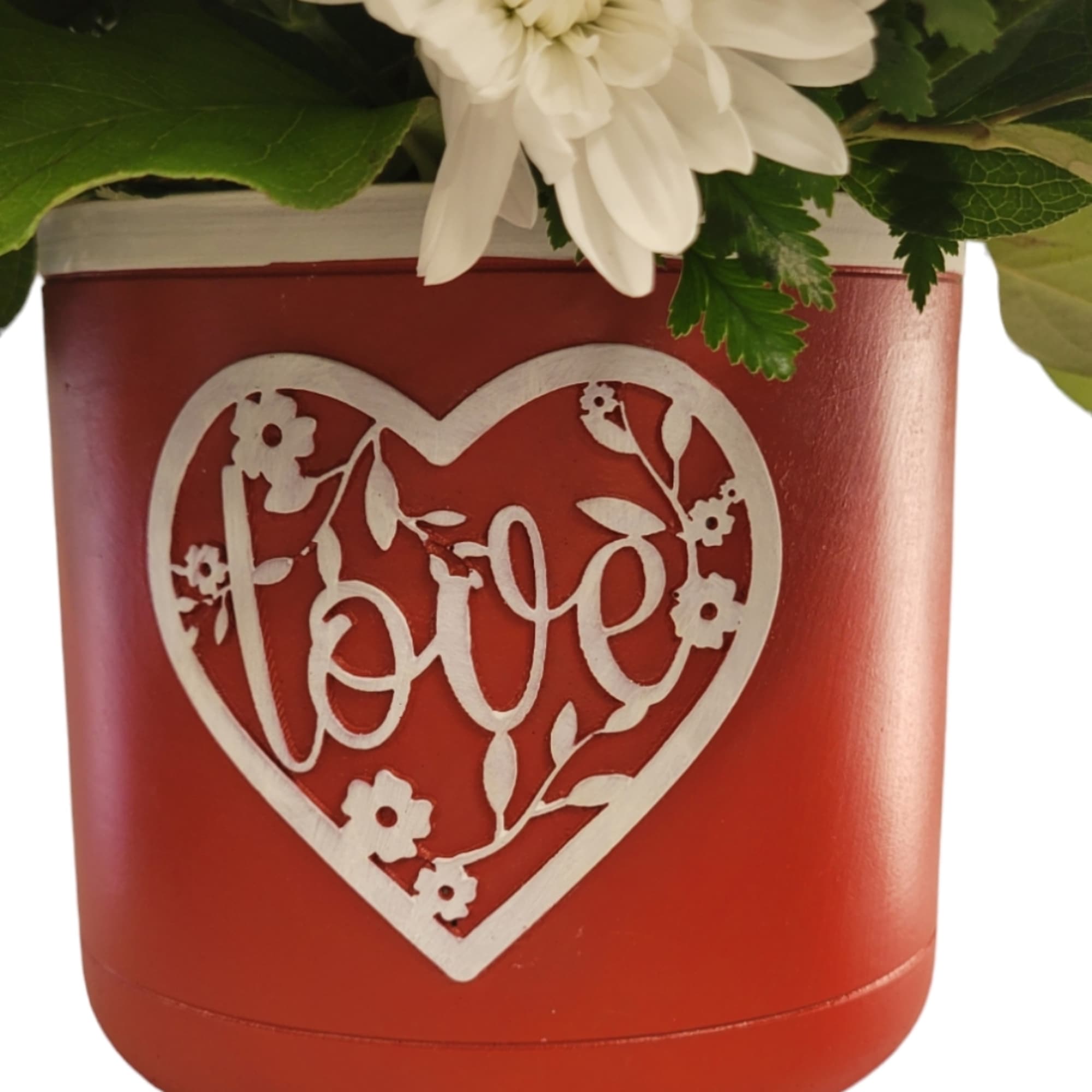 A red and white combination of flowers designed in a ceramic container