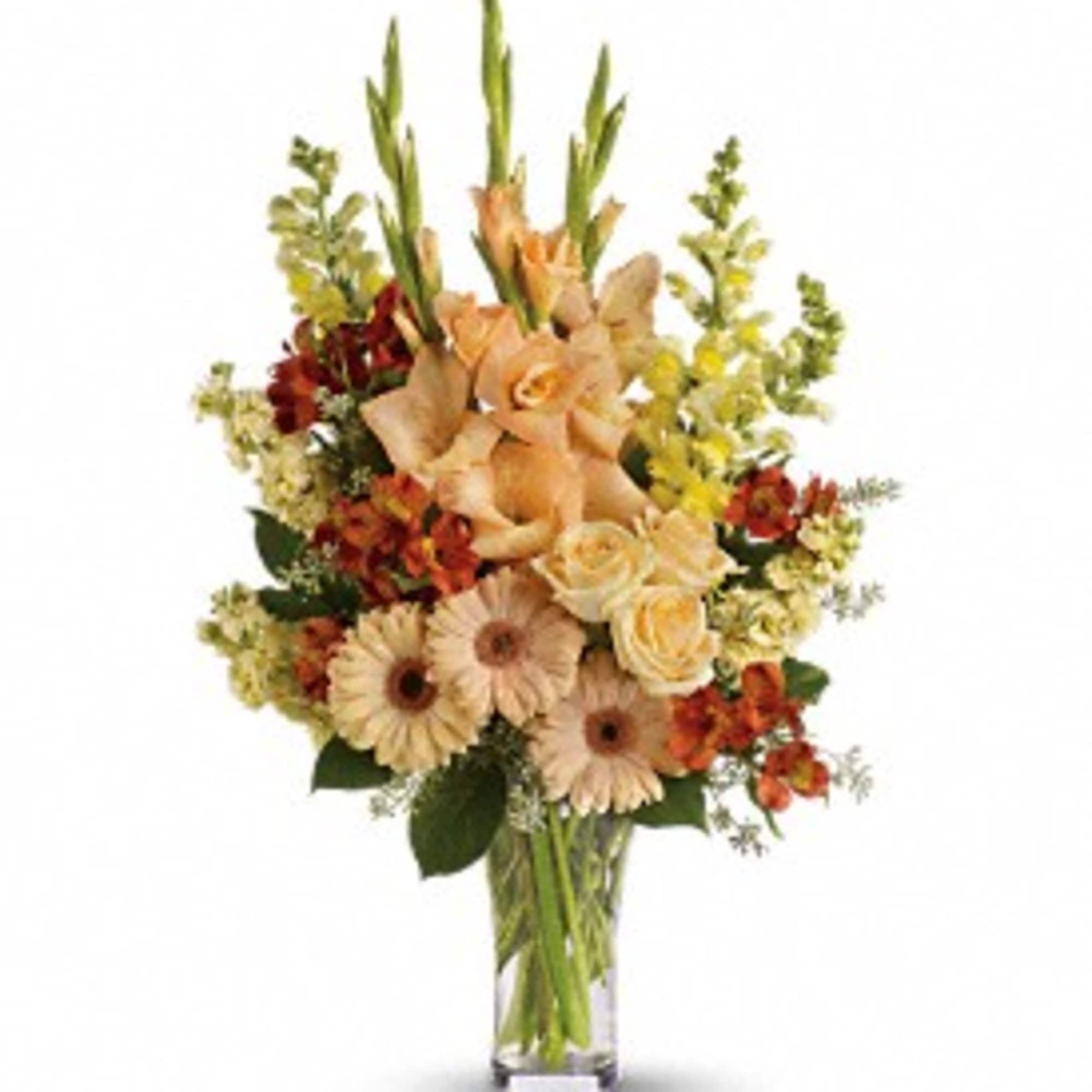 Peach and cream floral arrangement in a clear glass vase