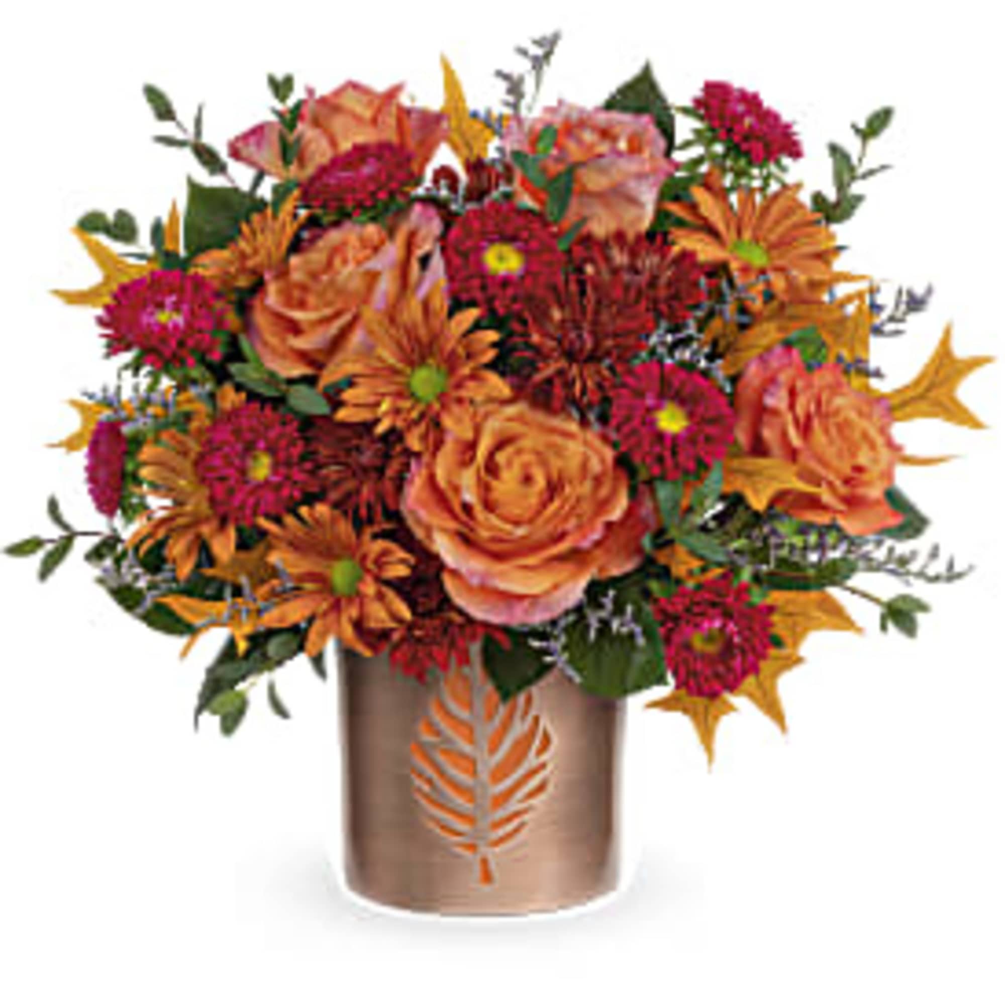 Orange and magenta flower arrangement in a bronze vase