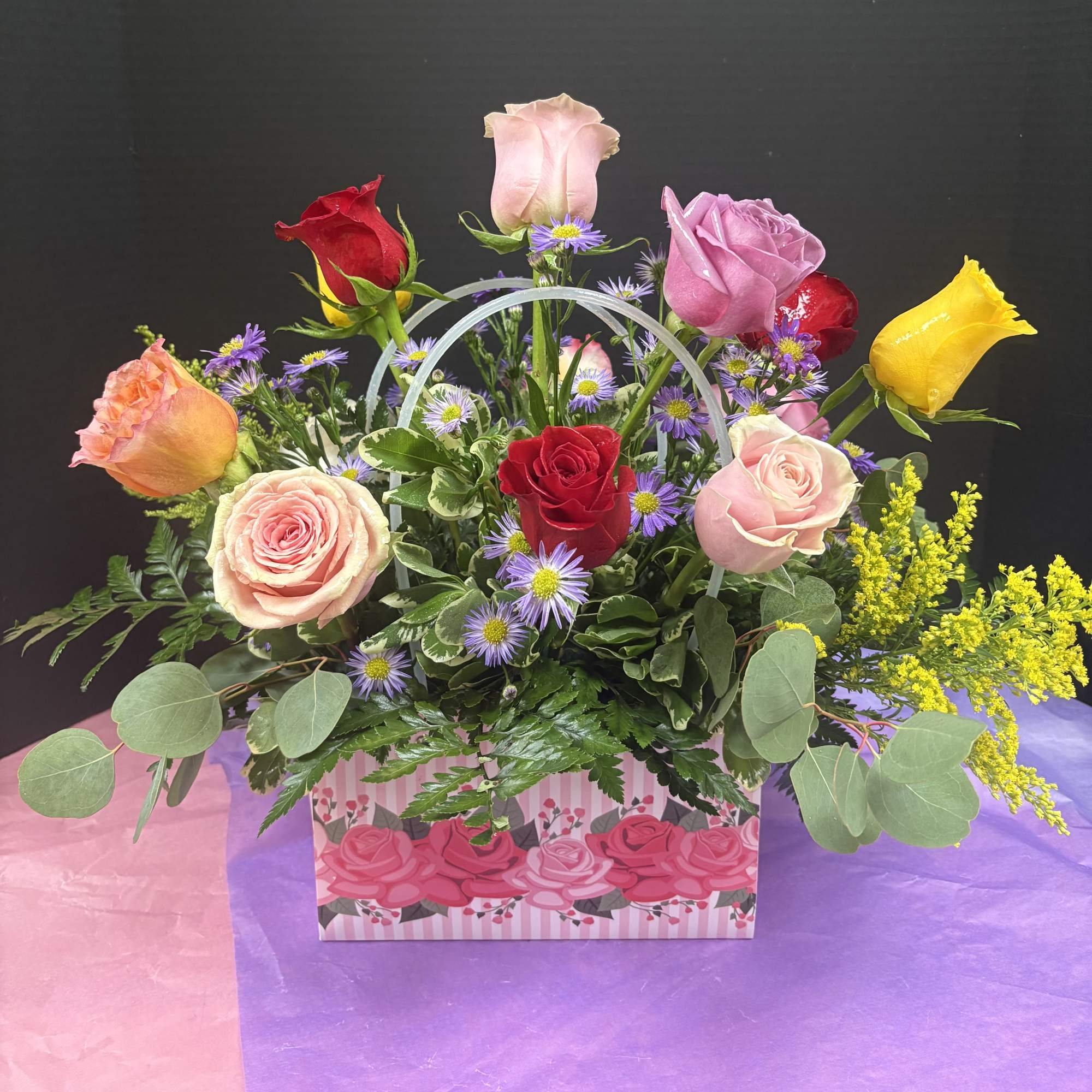 A bright, giftable presentation of mixed-color roses that reads like a bouquet