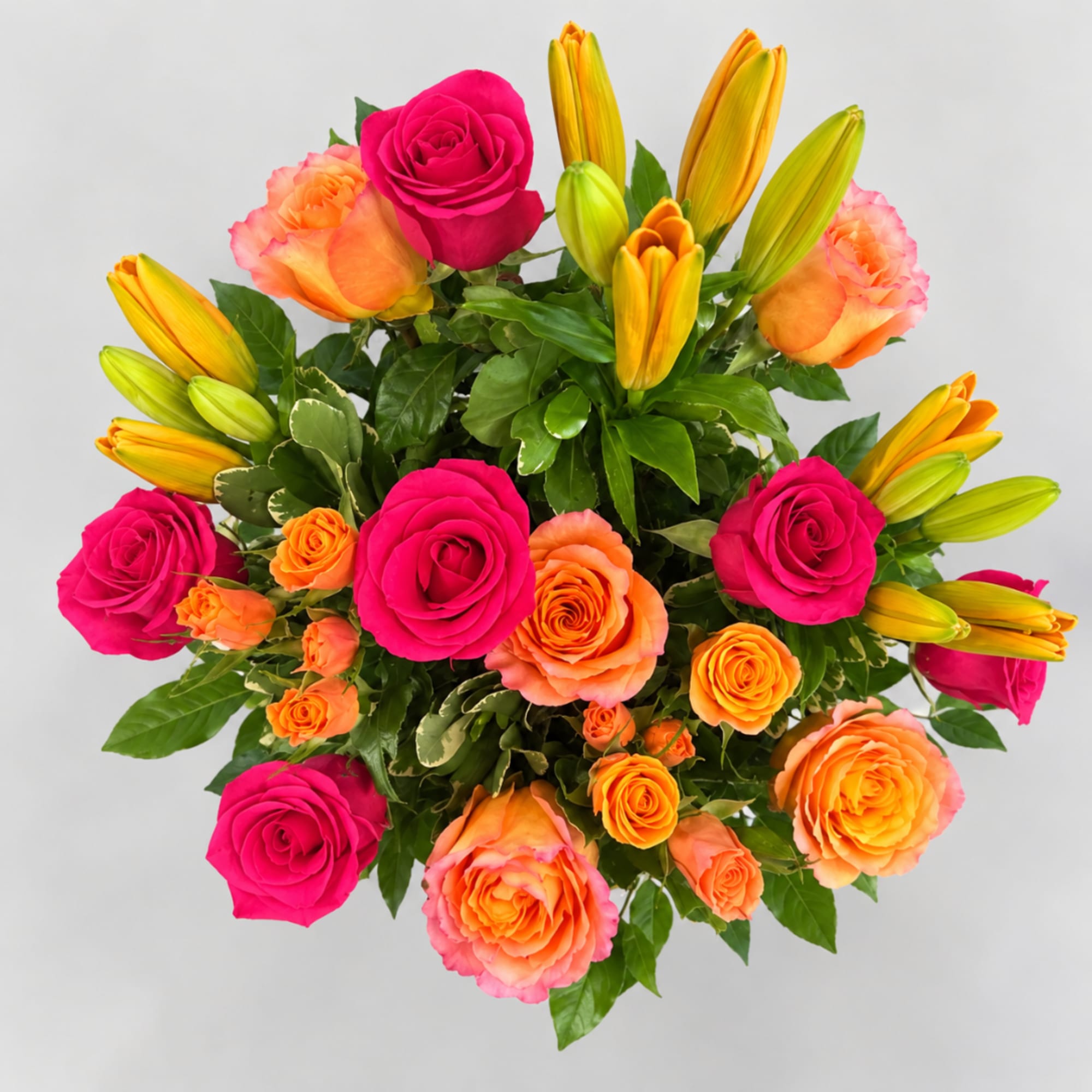 Bouquet of hot pink and peach roses with yellow lilies
